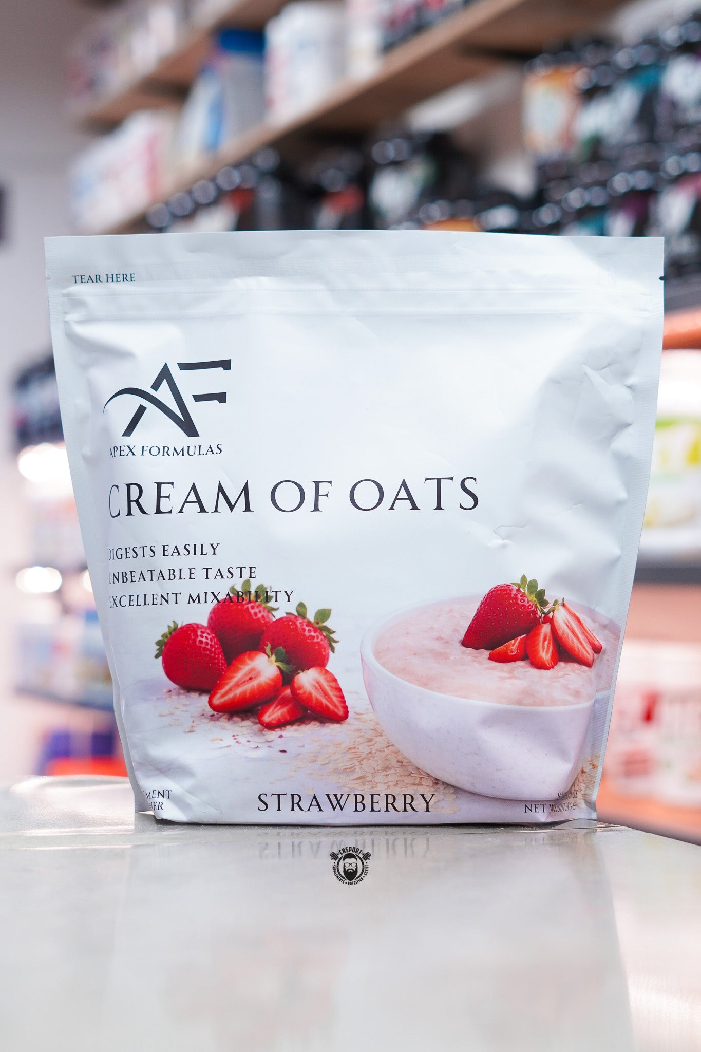 Apex Formulas Cream of Oats Strawberry flavour pouch displayed on a supplement store counter.