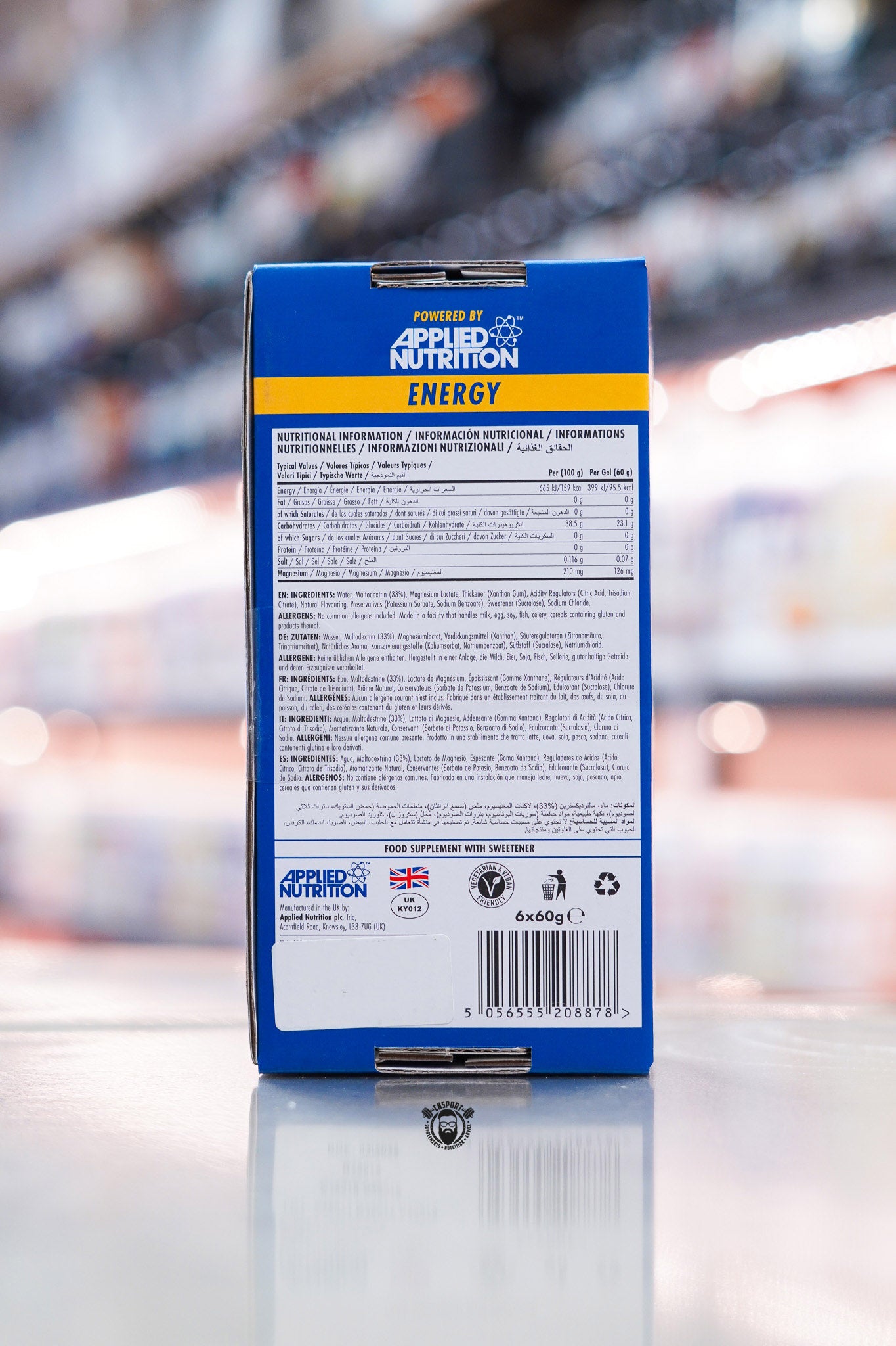Back panel of Applied Nutrition Endurance Energy Variety Pack showing nutritional information, ingredients and barcode on supplement store counter with blurred retail background
