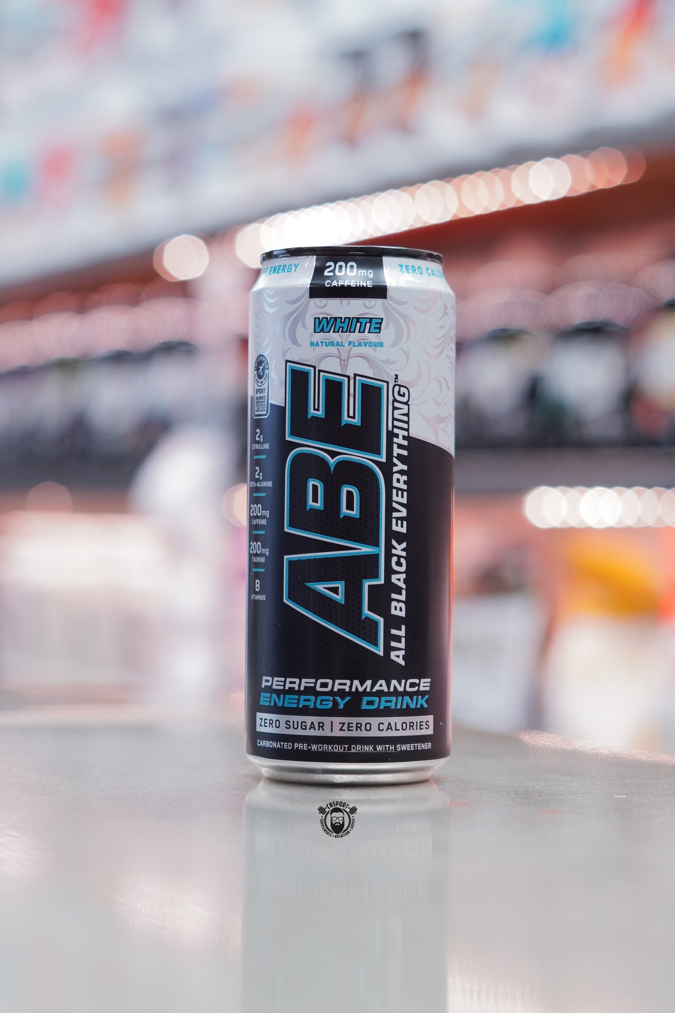 Applied Nutrition ABE Performance Energy Drink, White flavour, 330ml can with 200mg caffeine, zero sugar and zero calories, displayed on supplement store counter.