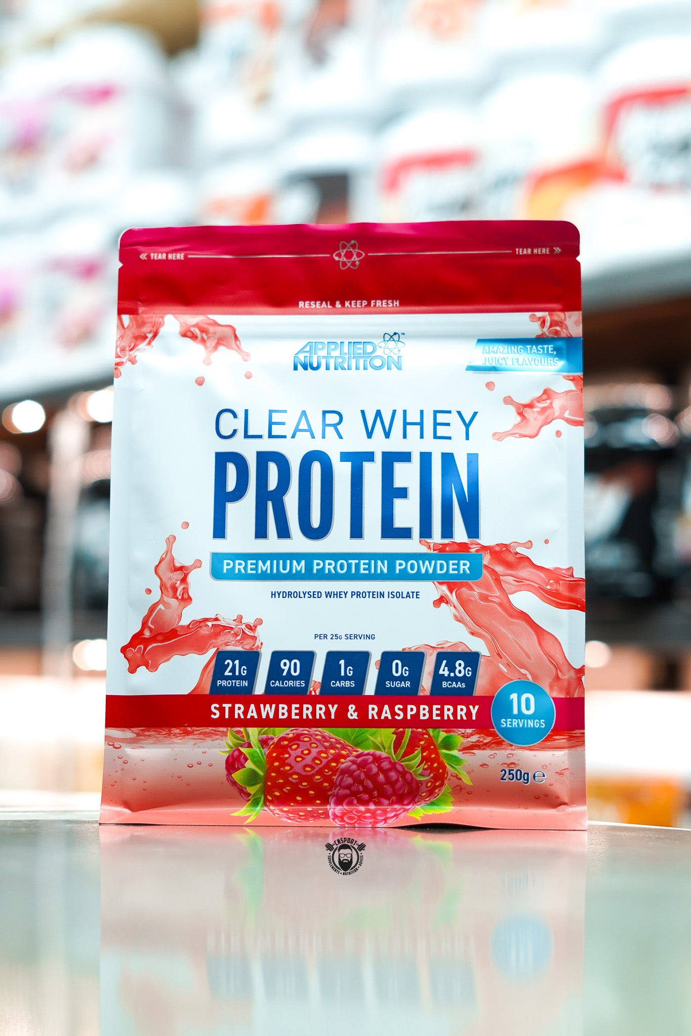 Front of a 250g pouch of Applied Nutrition Clear Whey Protein in Strawberry & Raspberry flavour, featuring 21g protein, 90 calories, 1g carbs, 0g sugar, and 4.8g BCAAs per serving.