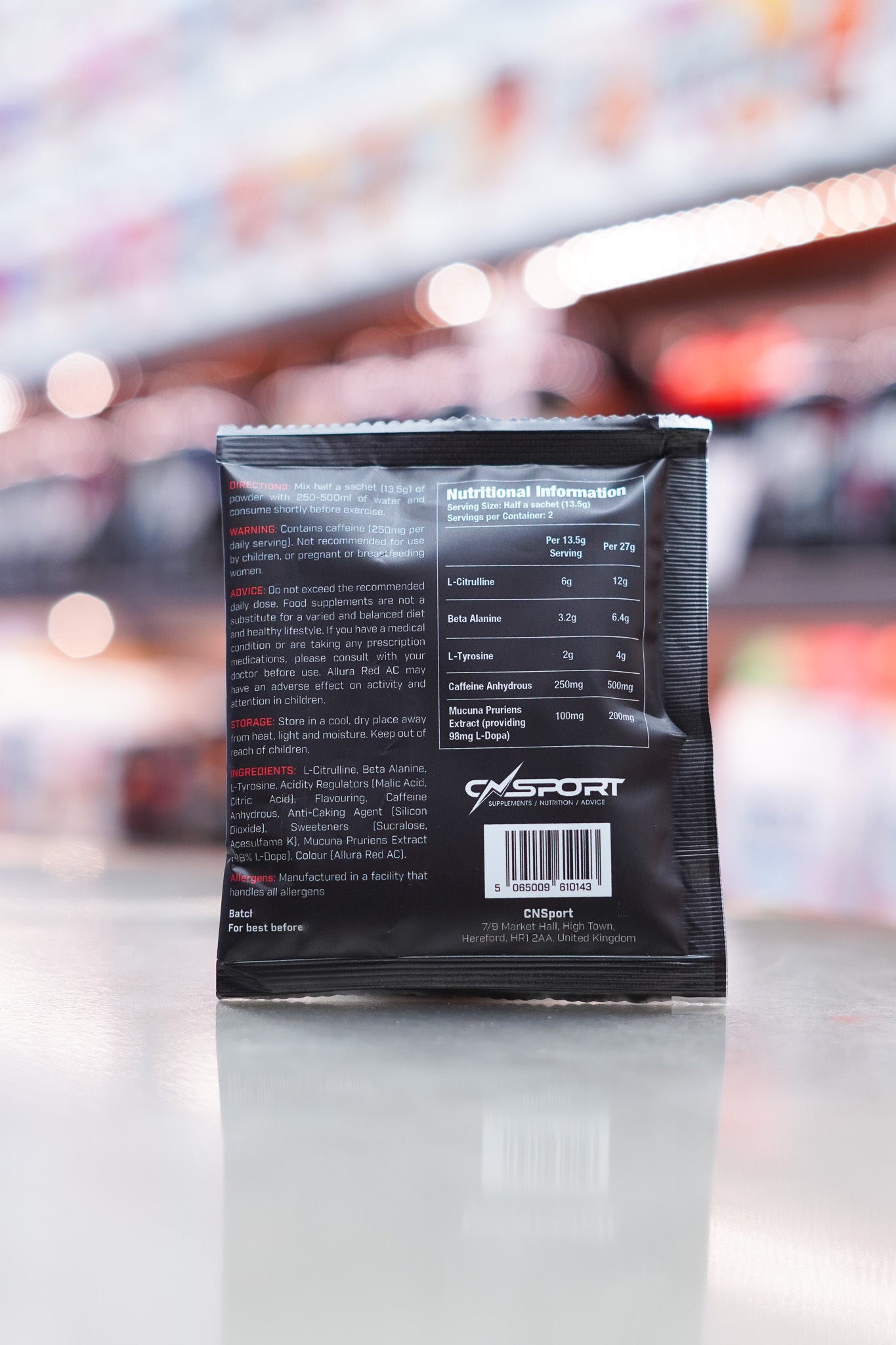 Back view of a CNSport Pandamonium Pre-Workout 27g Fruit Punch sample sachet showing full nutritional information, ingredients, warnings and barcode on a black packet with white text.
