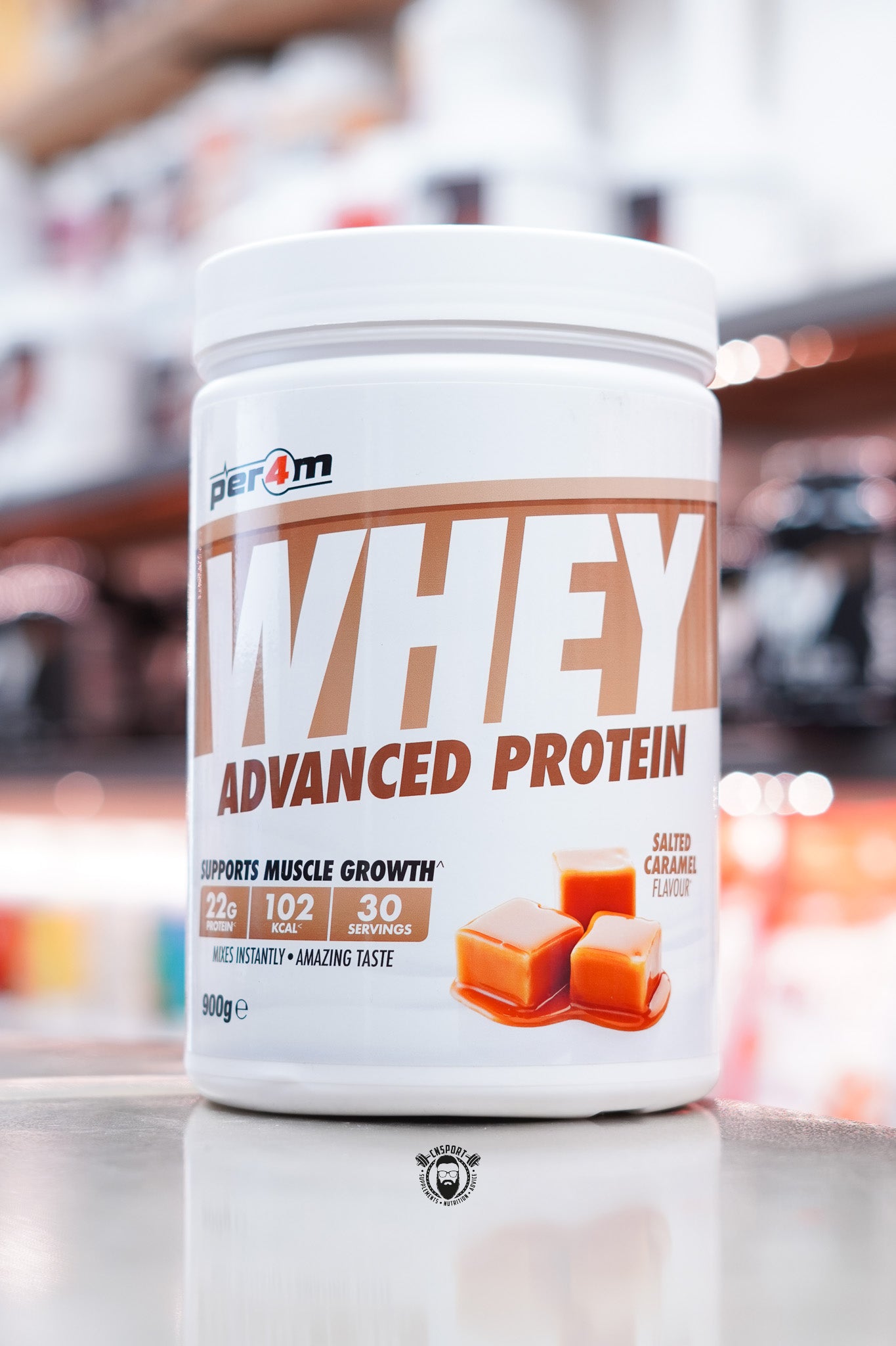 White tub of Per4m Whey Advanced Protein in salted caramel flavour, 30 servings, with caramel block illustration.