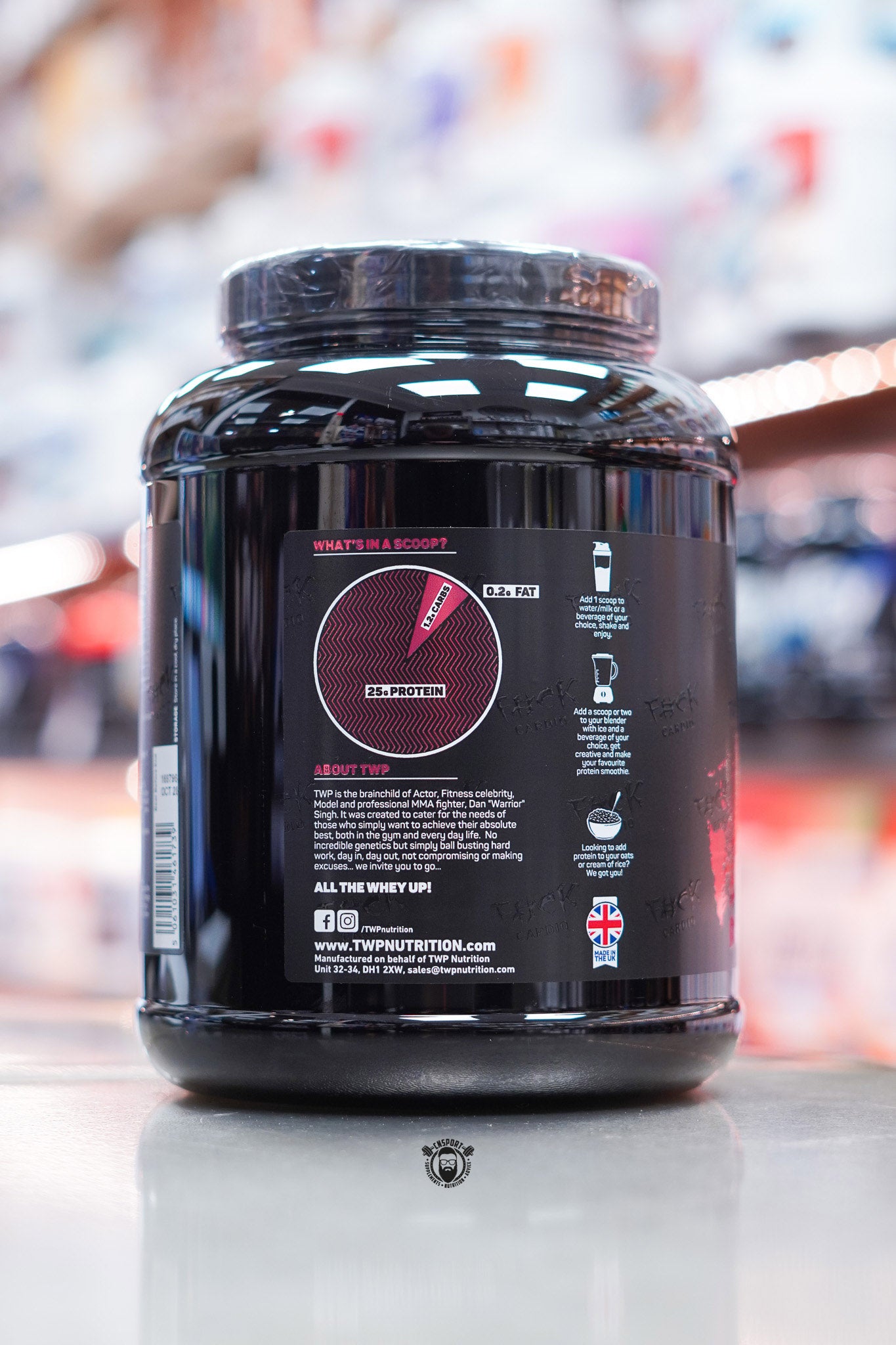 Side view of TWP All The Whey Iso Jam Roly Poly tub showing serving chart, brand story, and usage recommendations.