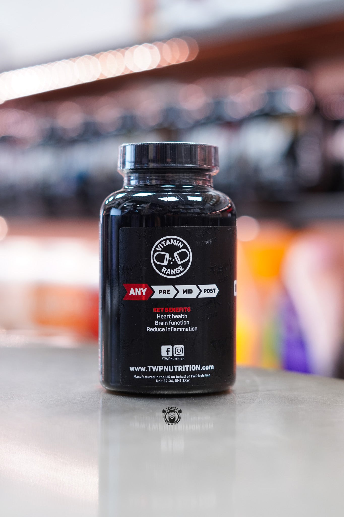 Side view of the TWP Omega-3 RAW bottle highlighting key benefits such as heart health, brain function, and inflammation reduction, with brand and social links visible.