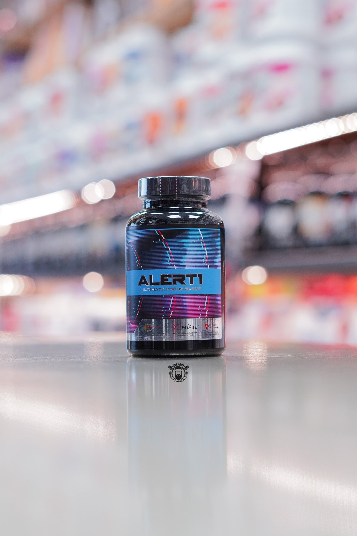 1 Source Supplements Alert 1 capsules bottle showing front label with “ALERT 1 – Ultimate Focus Blend” branding on a reflective surface