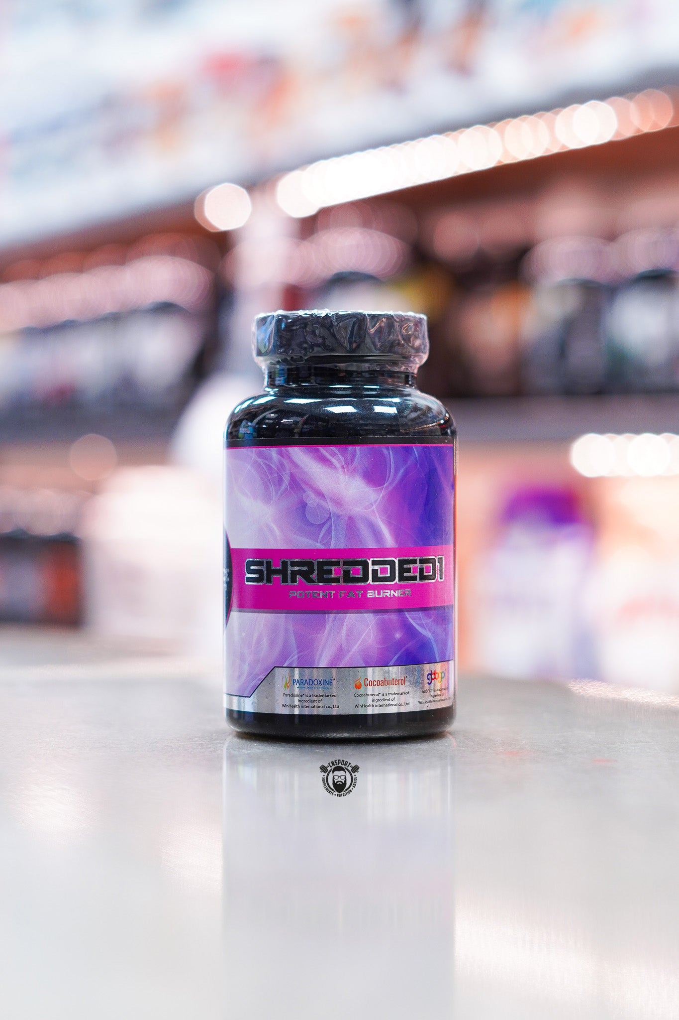 1 Source Supplements Shredded 1 potent fat burner capsules bottle, 30 servings, displayed on supplement store counter.
