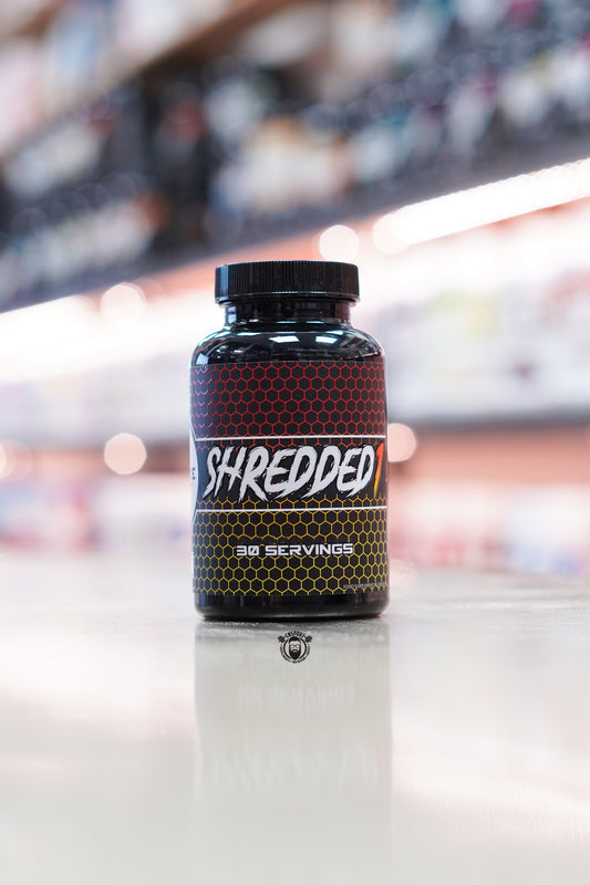1 Source Supplements Shredded 1 V2 thermogenic fat burner, 120-capsule bottle providing 30 servings, displayed on a supplement store counter.