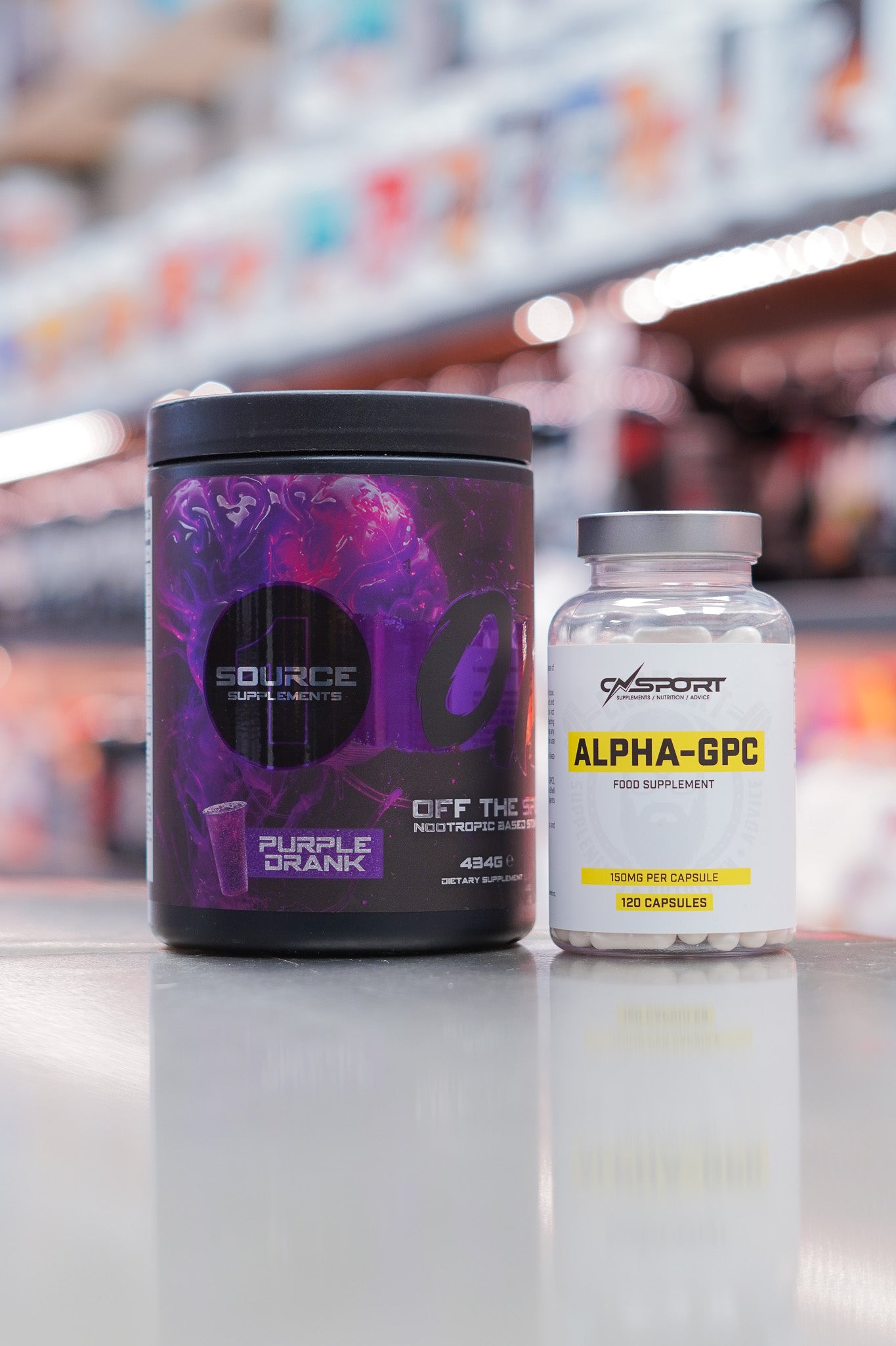 1 Source Supplements OTS pre-workout Purple Drank flavour (434g) with CNSport Alpha-GPC 150mg capsules (120 capsules) displayed on supplement store counter.