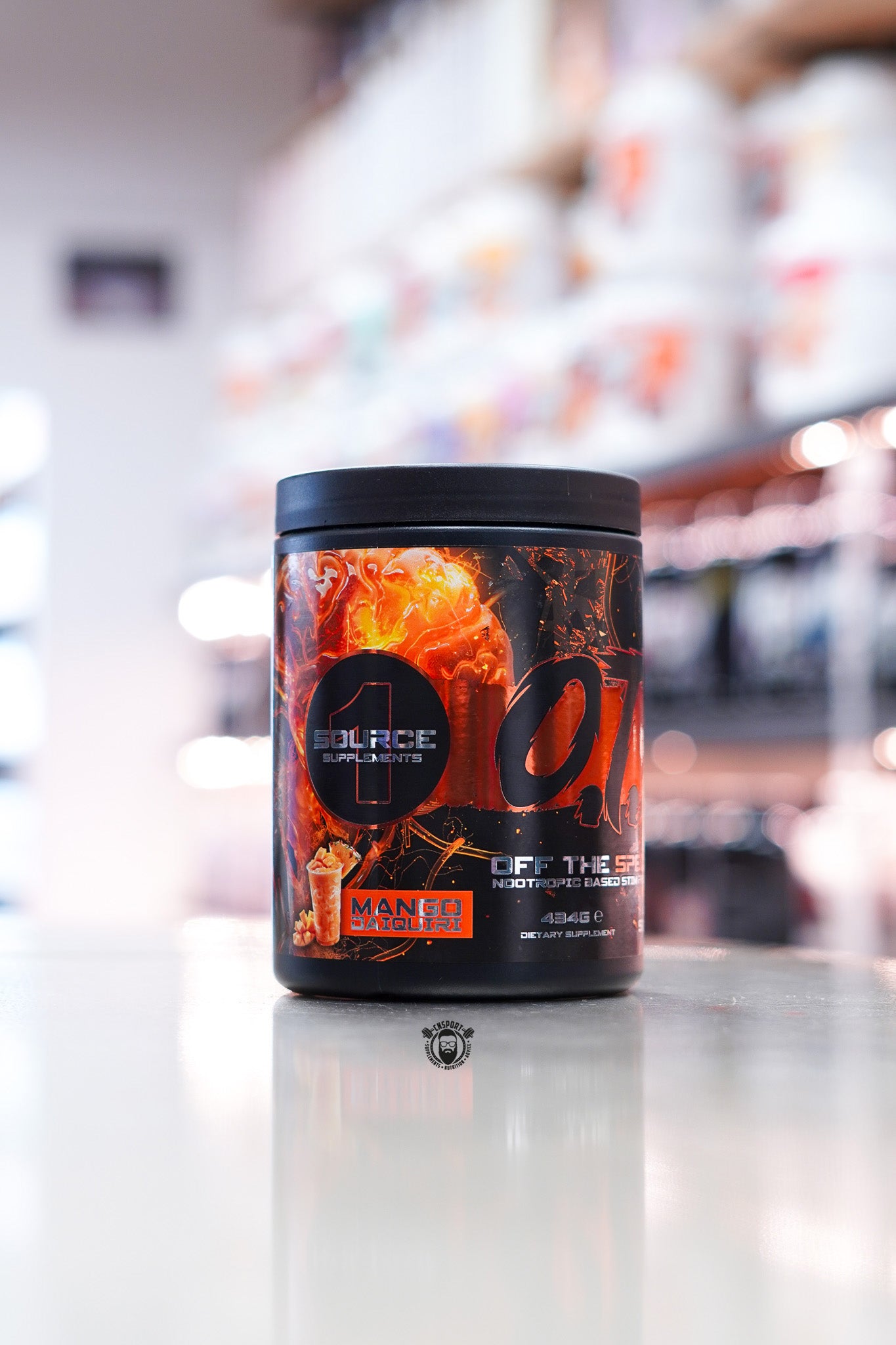 Source Supplements Off The Spectrum OTS Pre-Workout Mango Daiquiri flavour, 434g tub with 40 servings, displayed on a supplement store counter with orange and black label design.