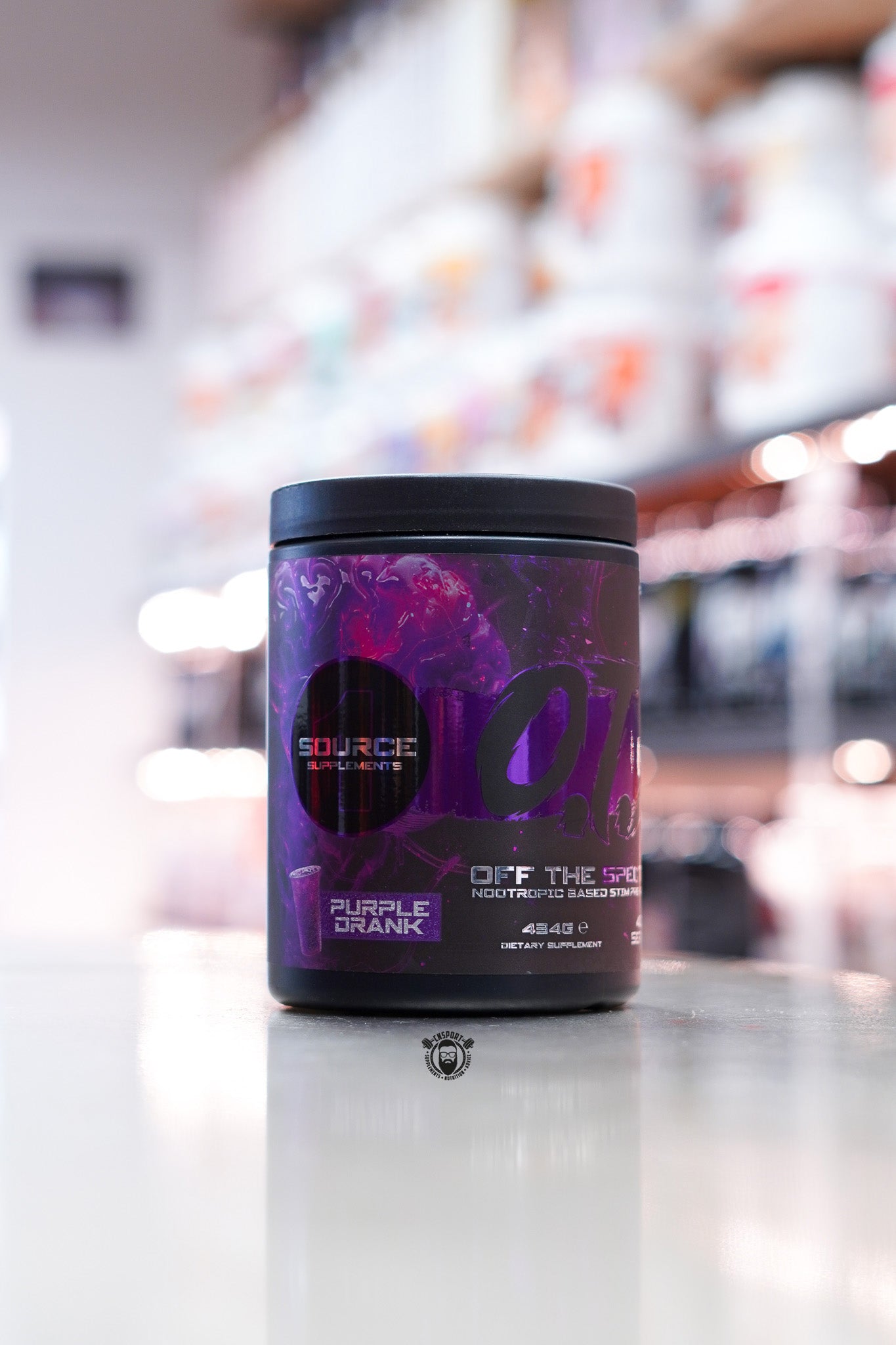 Source Supplements Off The Spectrum OTS Pre-Workout Purple Drank flavour, 434g tub with 40 servings, displayed on a supplement store counter with purple and black label design.