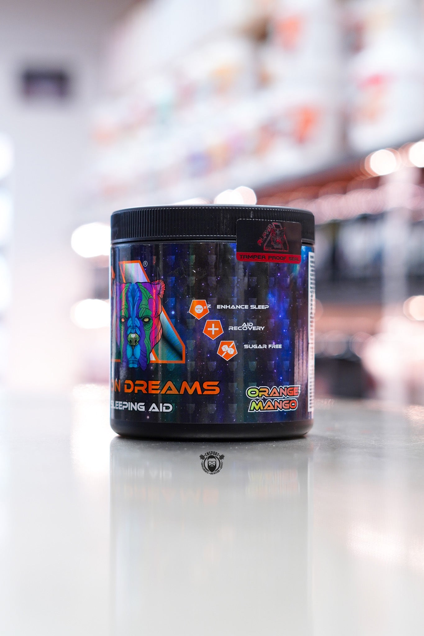Alpha Neon Neon Dreams sleep aid supplement tub, Orange Mango flavour, 30 servings, on supplement store counter.