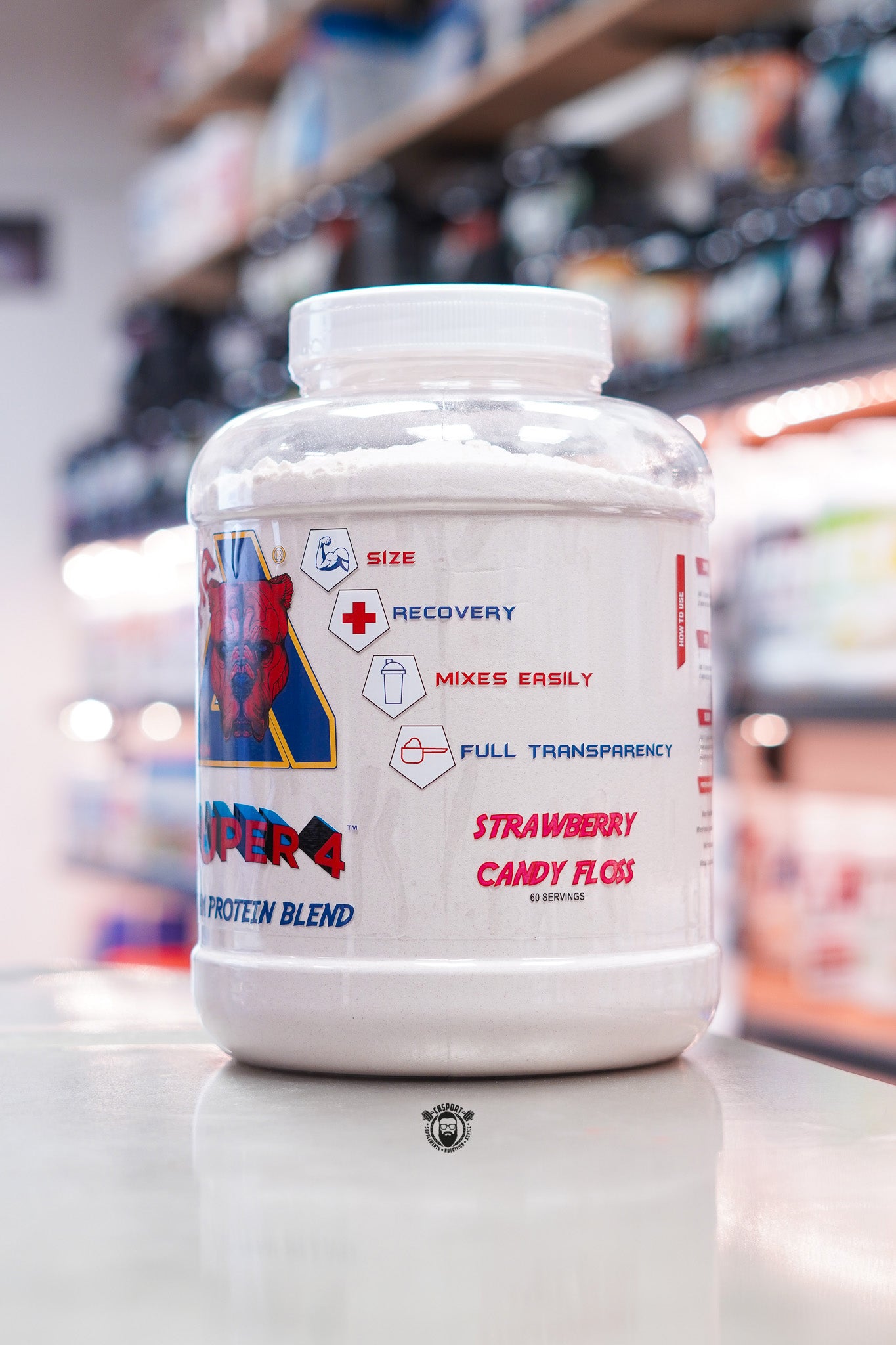 Alpha Neon Super 4 Protein Blend Strawberry Candy Floss flavour 2kg tub with 60 servings, displayed on a supplement shop counter.
