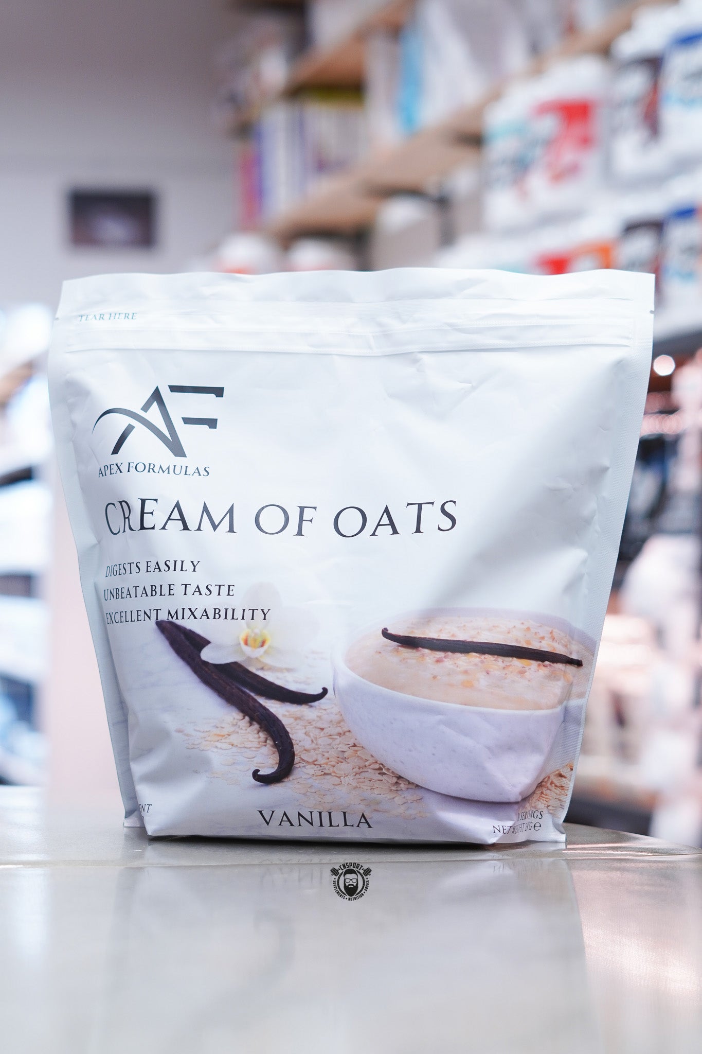 Apex Formulas Cream of Oats Vanilla flavour 2kg pouch displayed on supplement store counter.