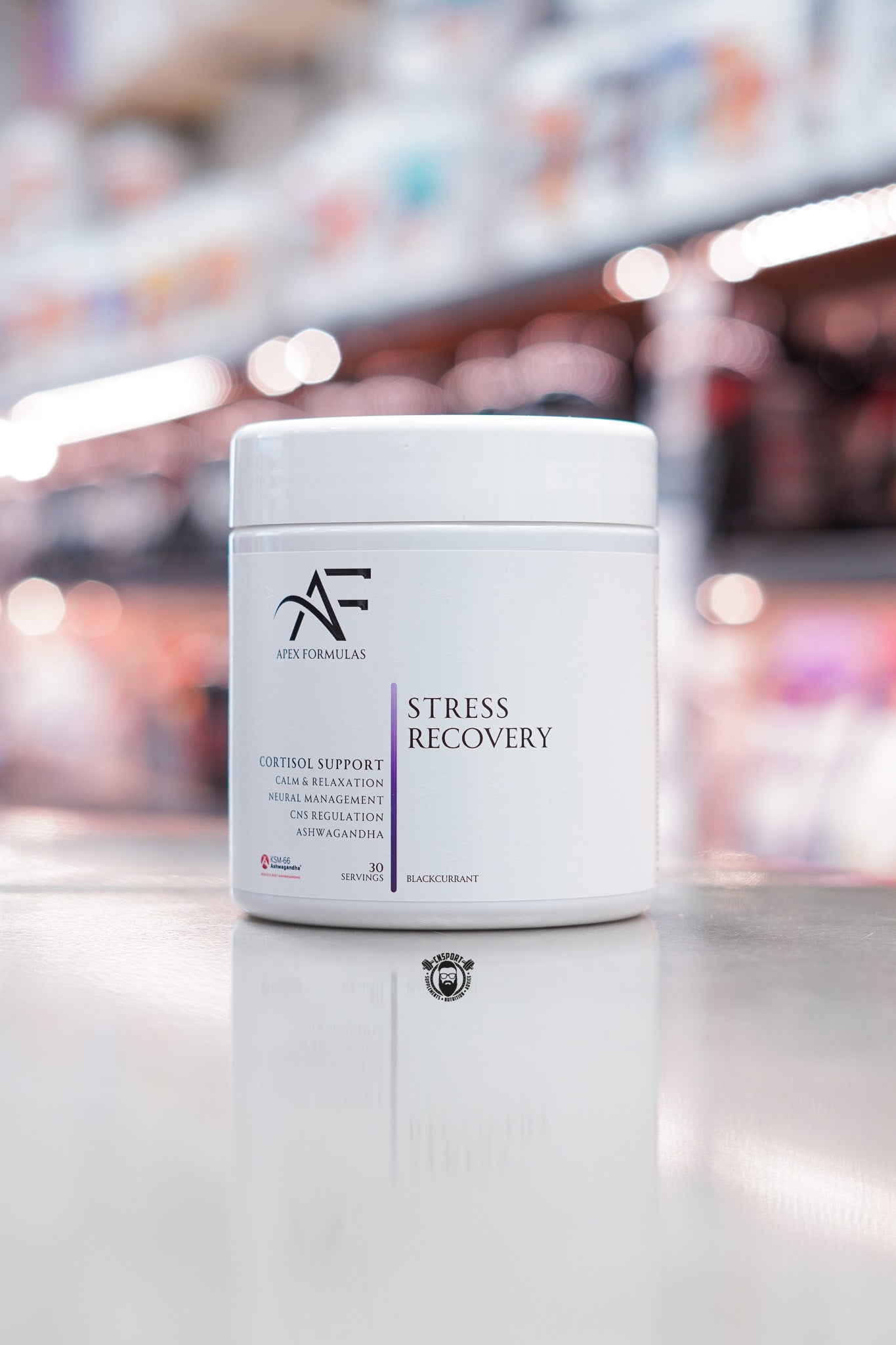 Apex Formulas Stress Recovery powder, Blackcurrant flavour, 30 servings, white tub displayed on supplement store counter.