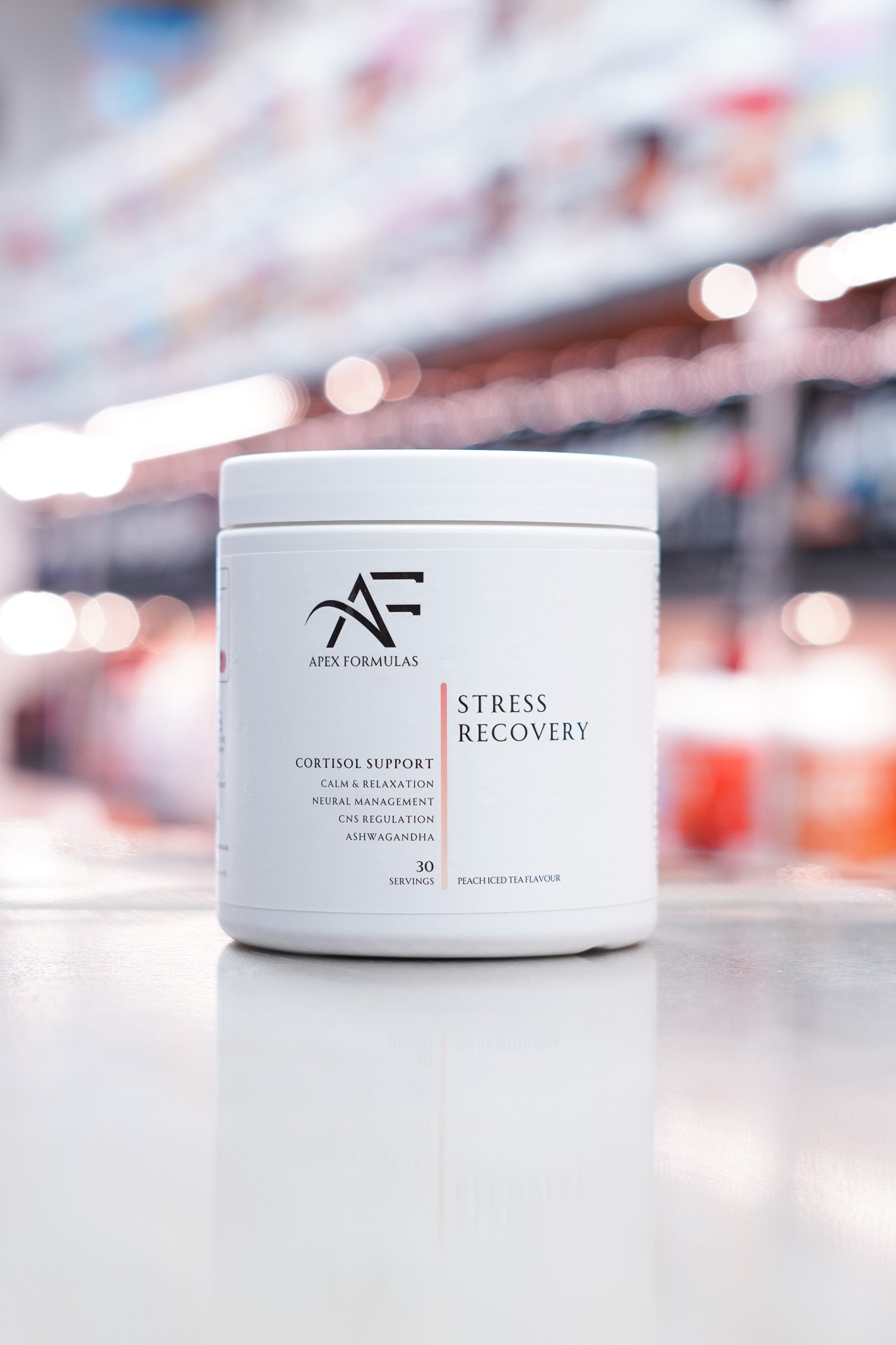 Apex Formulas Stress Recovery tub highlighting benefits such as cortisol support, calm and relaxation, neural management, and CNS regulation. Flavour is Peach Iced Tea with 30 servings.