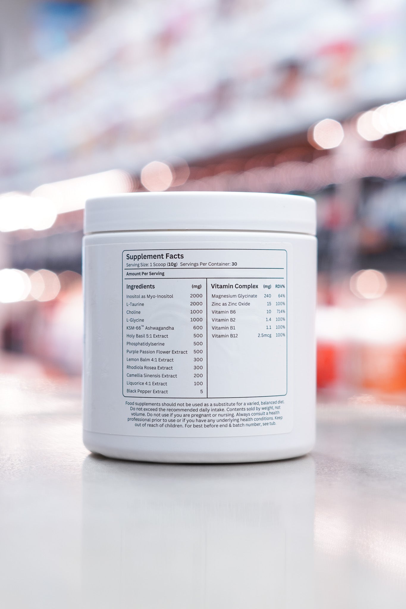 Back of Apex Formulas Stress Recovery Peach Iced Tea tub displaying supplement facts with a detailed breakdown of ingredients and vitamin complex per serving.