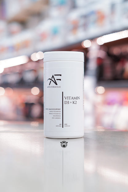 Apex Formulas Vitamin D3 + K2 capsules, 120 capsules, bone and immune support formula with magnesium, zinc and boron, white bottle displayed on supplement store counter.