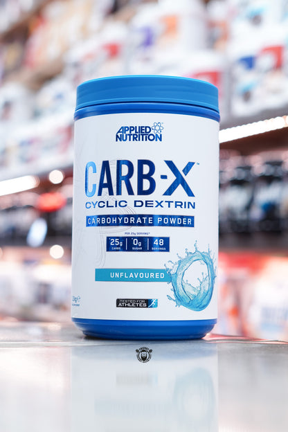 Front-facing image of Applied Nutrition Carb-X Unflavoured variant with blue water splash design and clear carbohydrate information on the label.