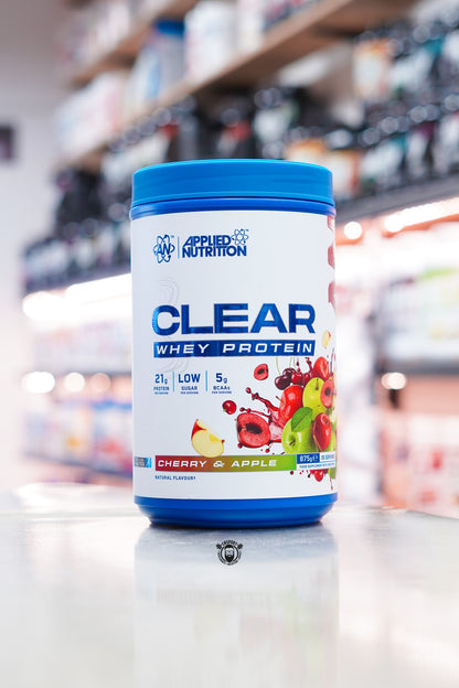 Applied Nutrition Clear Whey Protein Cherry & Apple flavour 875g tub with 35 servings displayed on a supplement shop counter.