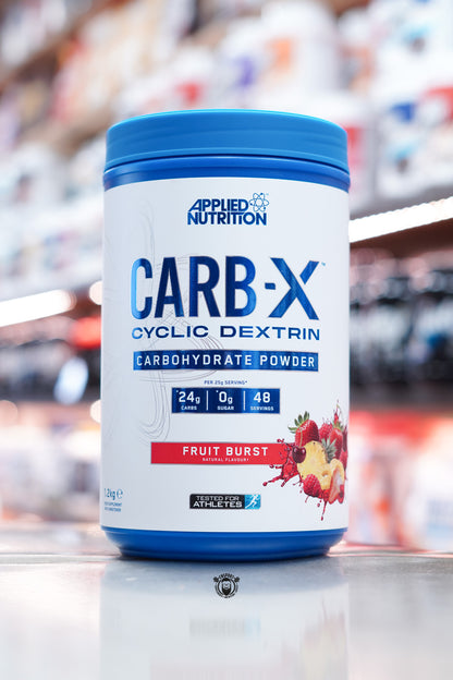 Front-facing image of Applied Nutrition Carb-X Fruit Burst flavour, featuring bright blue and red label with fruit graphics and serving details.