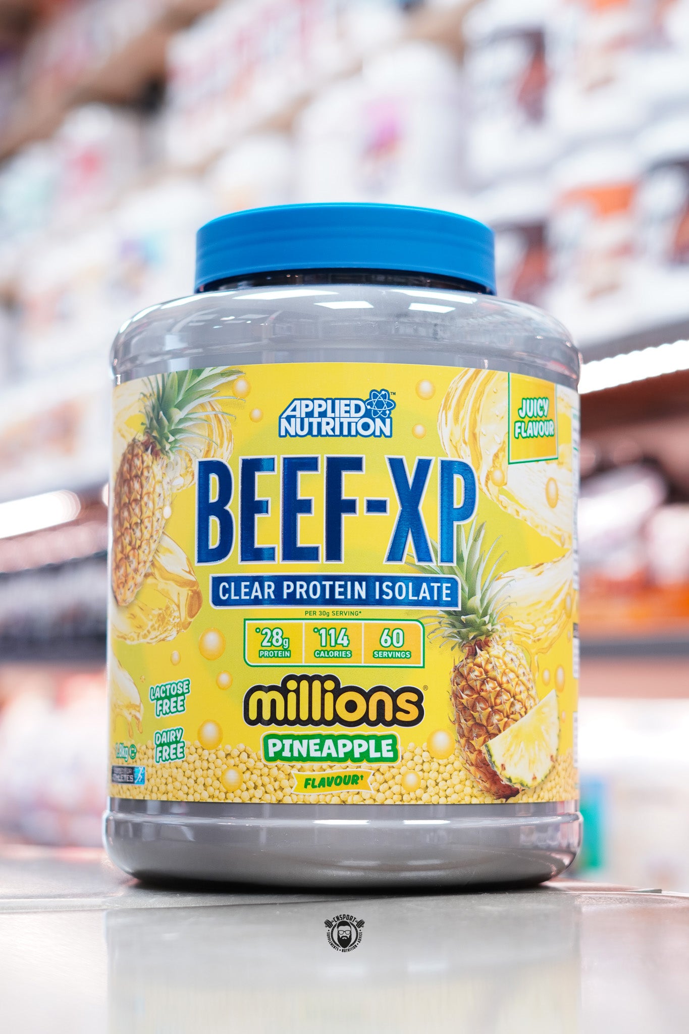 Front of Applied Nutrition Beef-XP Millions Pineapple flavour protein isolate with pineapple illustrations and nutritional highlights.