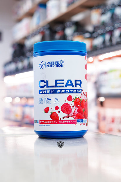Applied Nutrition Clear Whey Protein Strawberry Raspberry flavour 875g tub with 35 servings displayed on a supplement shop counter.
