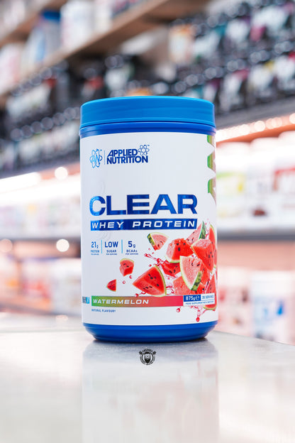 Applied Nutrition Clear Whey Protein Watermelon flavour 875g tub with 21g protein per serving displayed on a supplement shop counter.