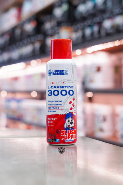 Applied Nutrition L-Carnitine Liquid 3000 Cherry Chill Slush Puppie flavour bottle with red cap displayed on a supplement shop counter.