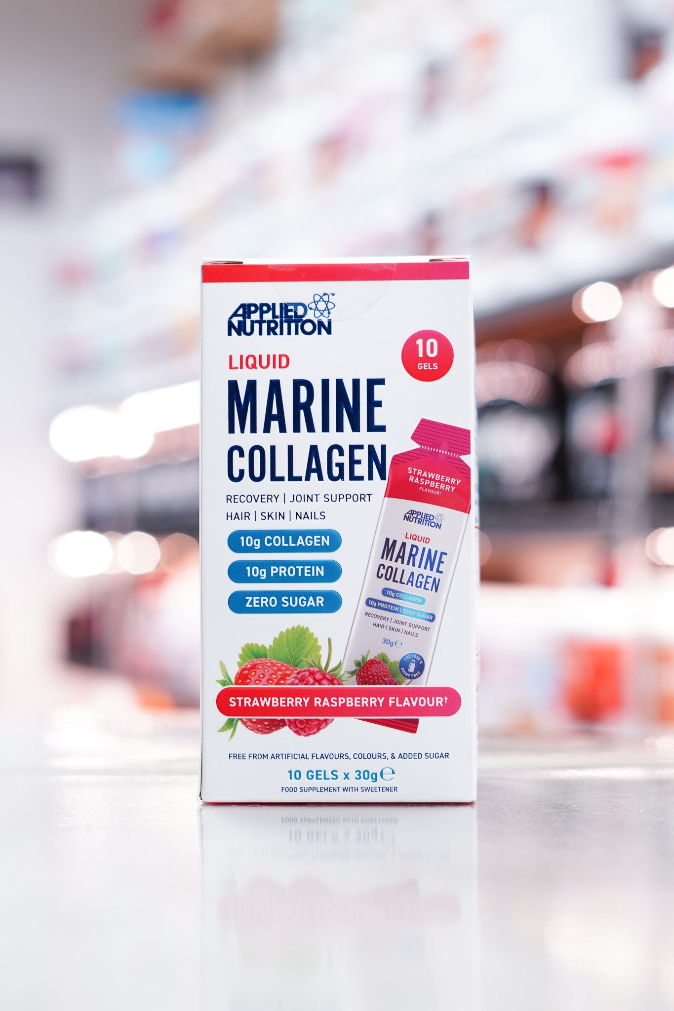 Front of the box showing product name, flavour, collagen and protein content, and imagery of strawberries and raspberries.