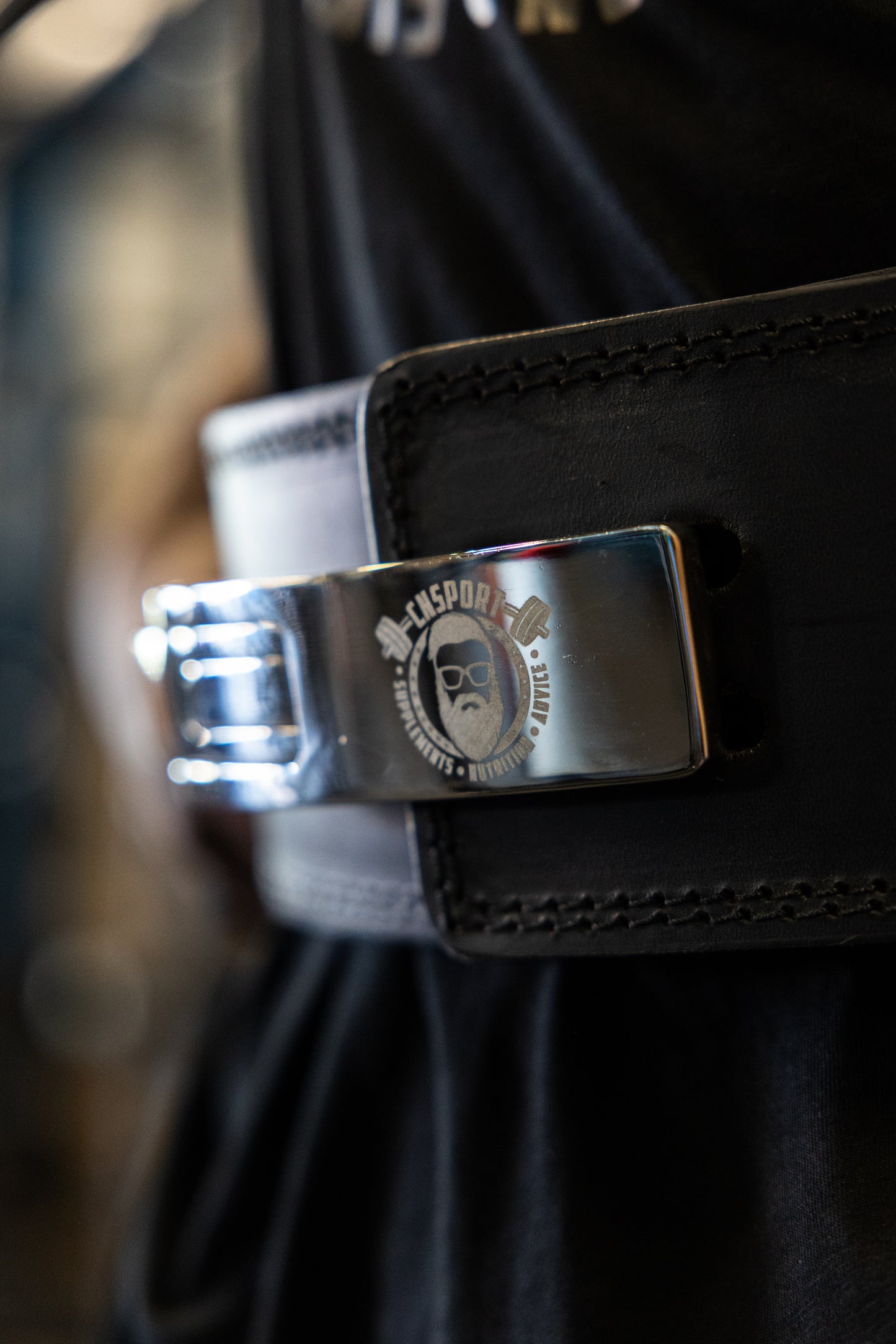 CNSport Lever Belt buckle detail showing engraved logo on chrome finish