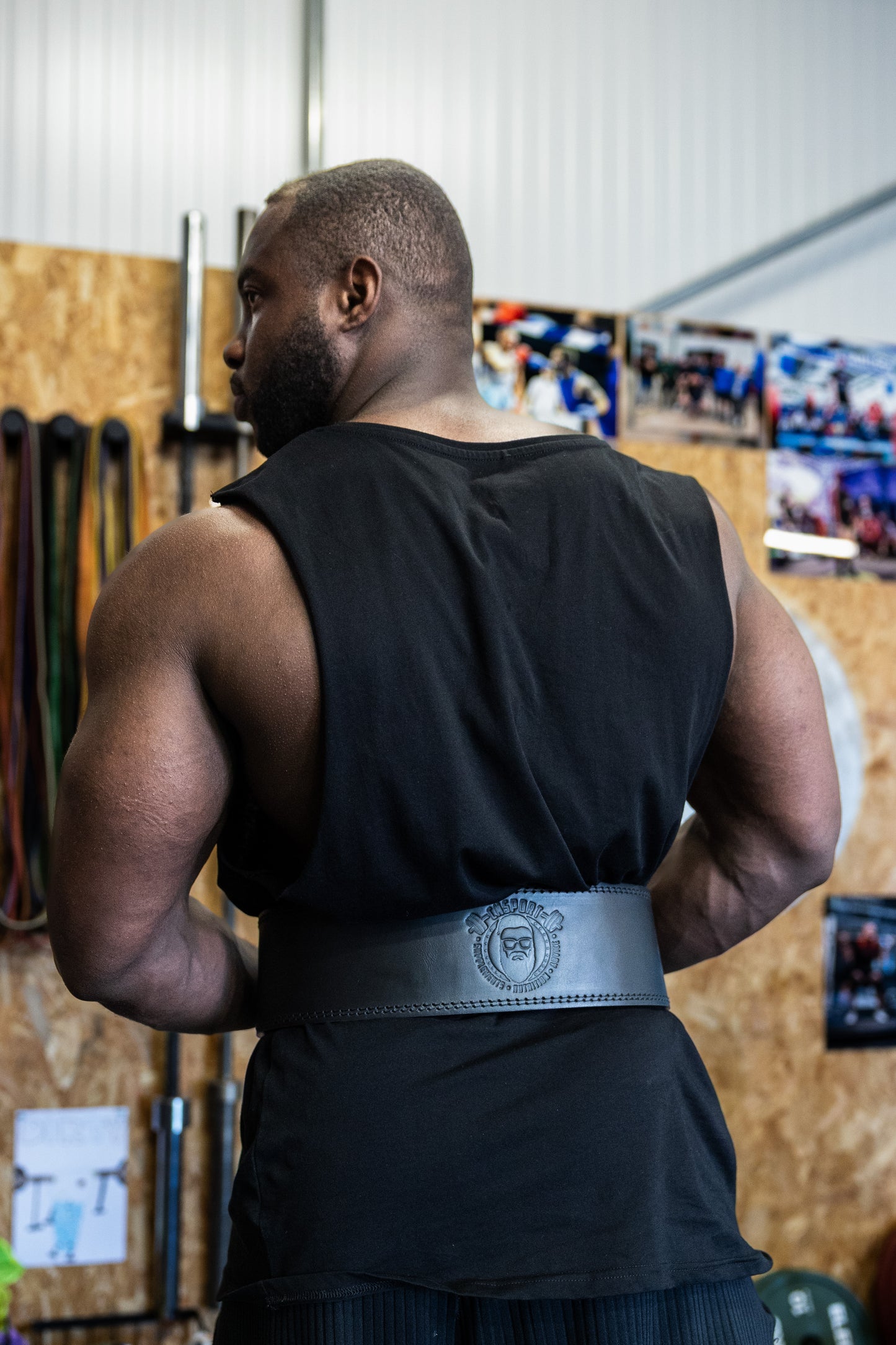 Athlete wearing CNSport Lever Belt from behind in gym environment