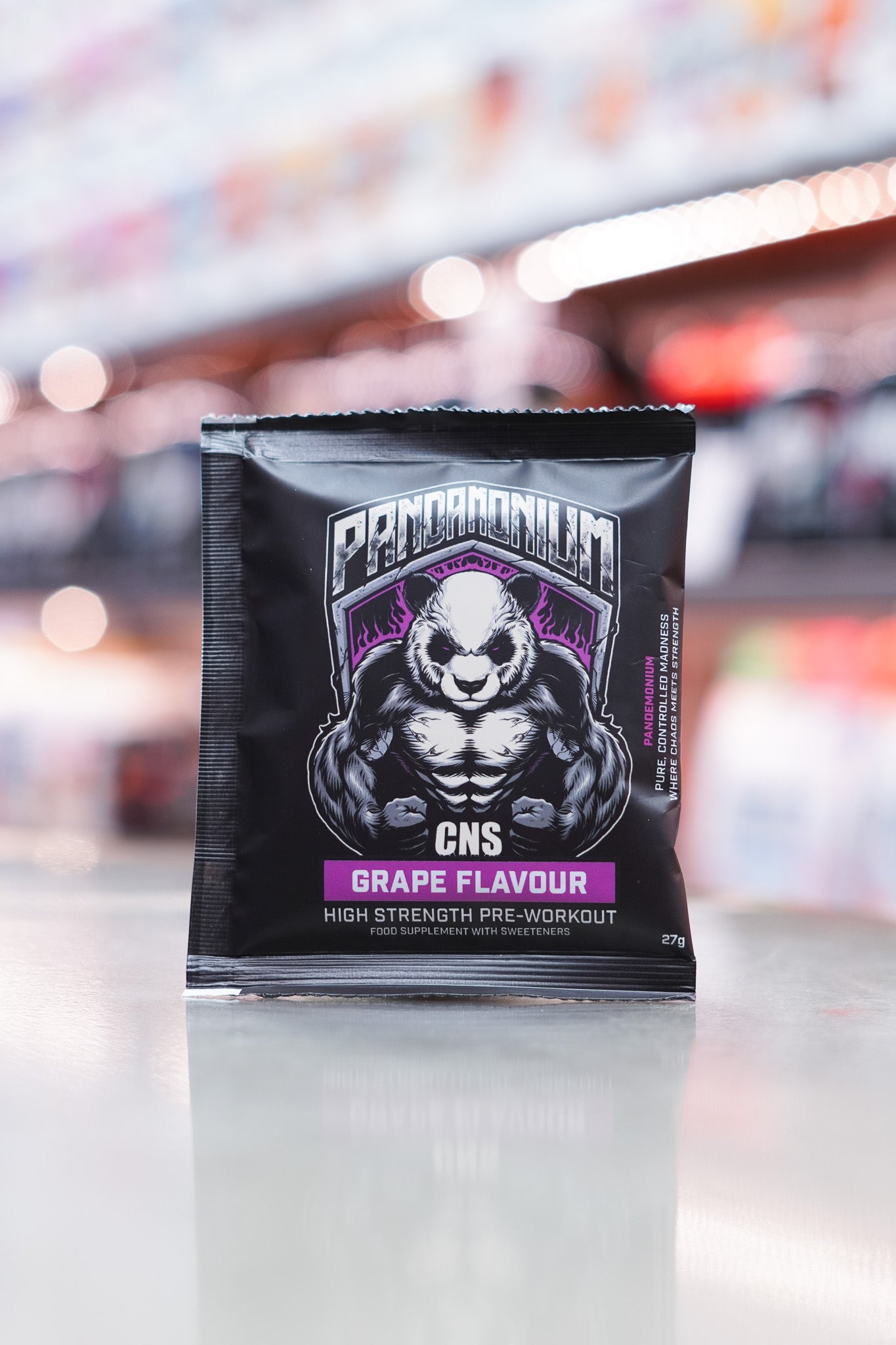 Front view of a CNSport Pandamonium Pre-Workout 27g Grape flavour sample sachet featuring the muscular panda graphic with purple accents and product branding.