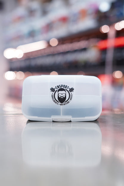 Closed CNSport clear pill box with black CNSport logo displayed on the front lid, positioned on a glossy countertop