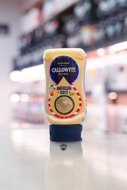 Callowfit American Mayo Style low sugar sauce bottle, limited edition packaging with Nutri-Score B, displayed upright on a countertop in a supplement store.
