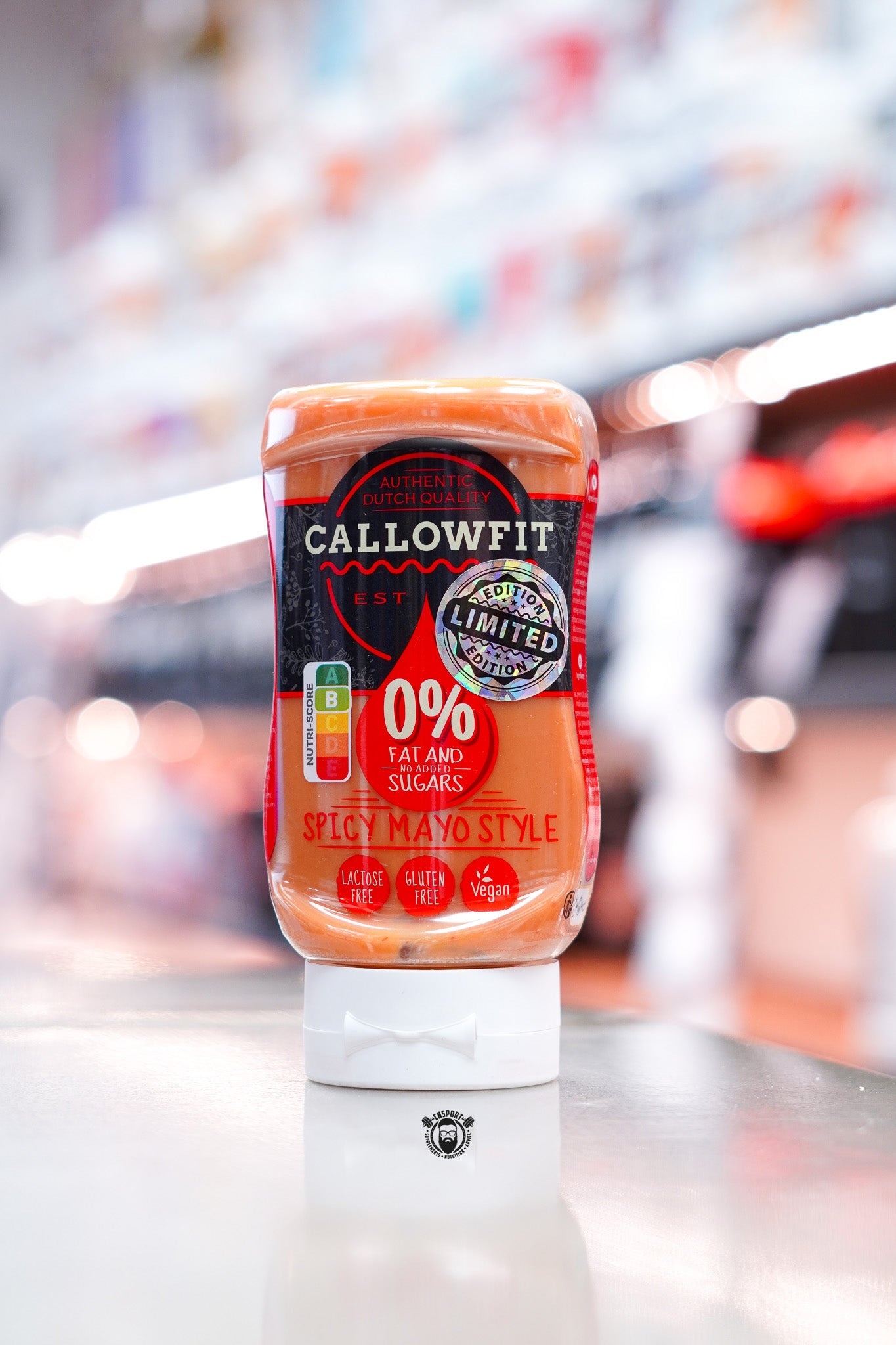 Callowfit Spicy Mayo Style sauce, 300ml squeeze bottle, 0% fat and no added sugars, lactose free, gluten free and vegan, displayed on counter in supplement store.