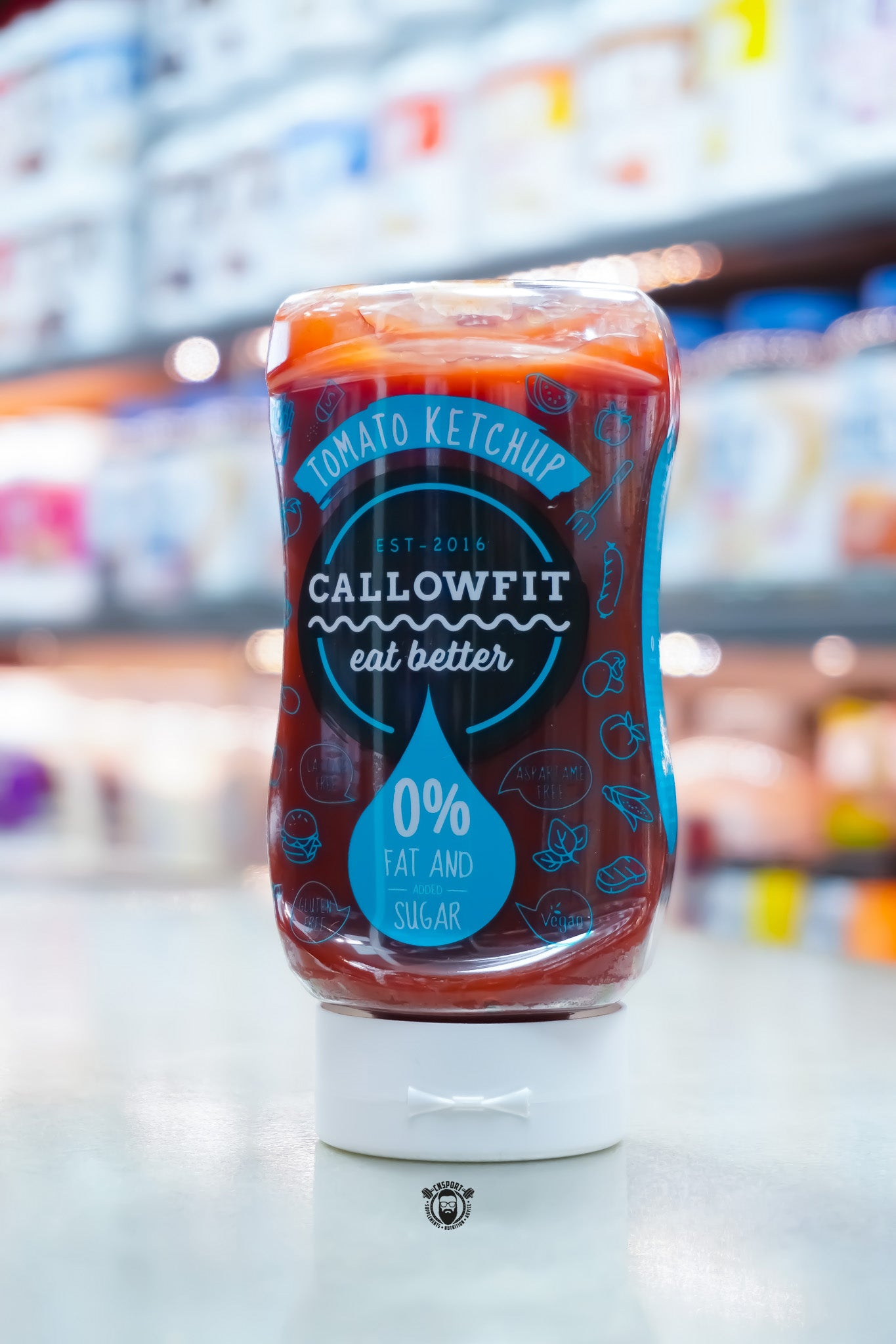 Callowfit Tomato Ketchup Sauce 300ml bottle with 0% fat and added sugar branding, lactose-free, gluten-free, vegan and aspartame-free, displayed upright in a supplement store.