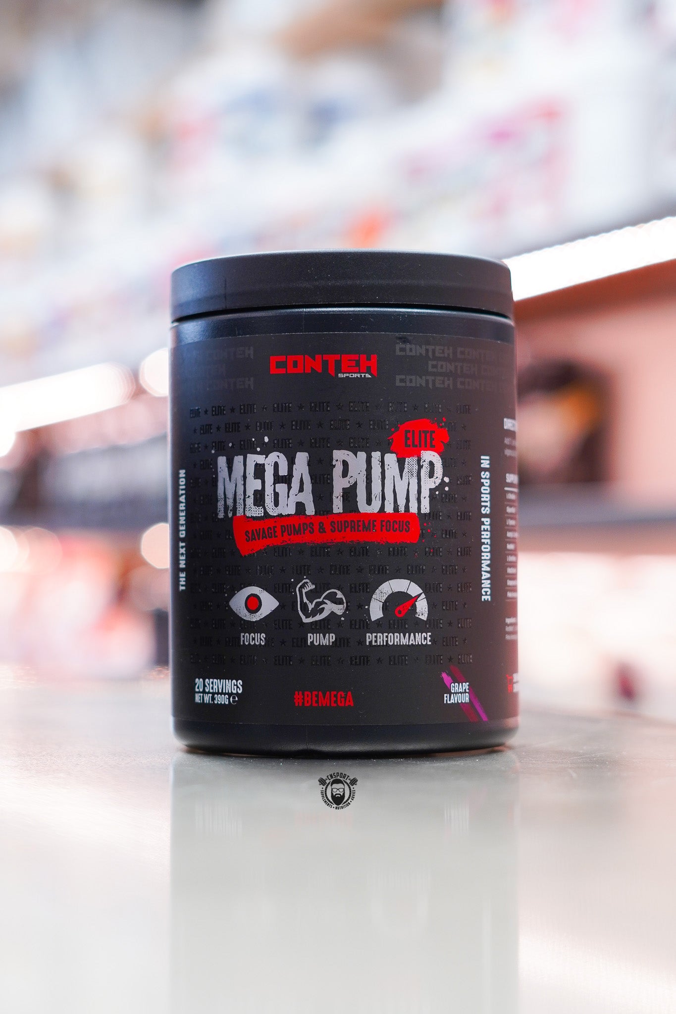 Conteh Sports Mega Pump Elite pre-workout tub, Grape flavour, displayed on supplement store counter.