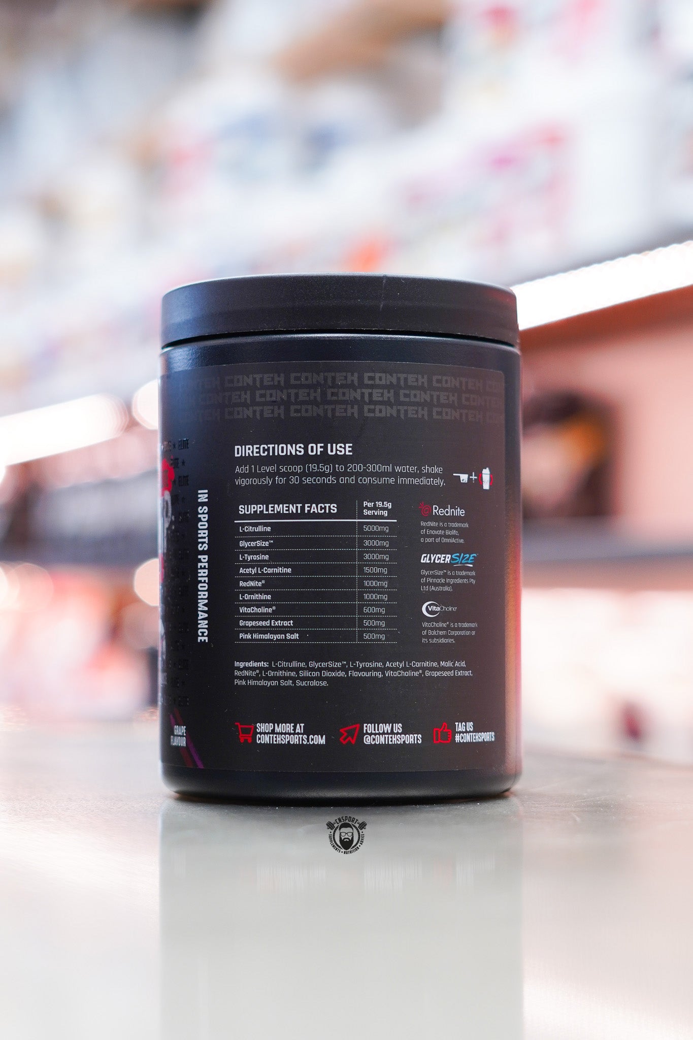 Conteh Sports Mega Pump Elite pre-workout tub, Grape flavour, product information and warning panel shown on back.