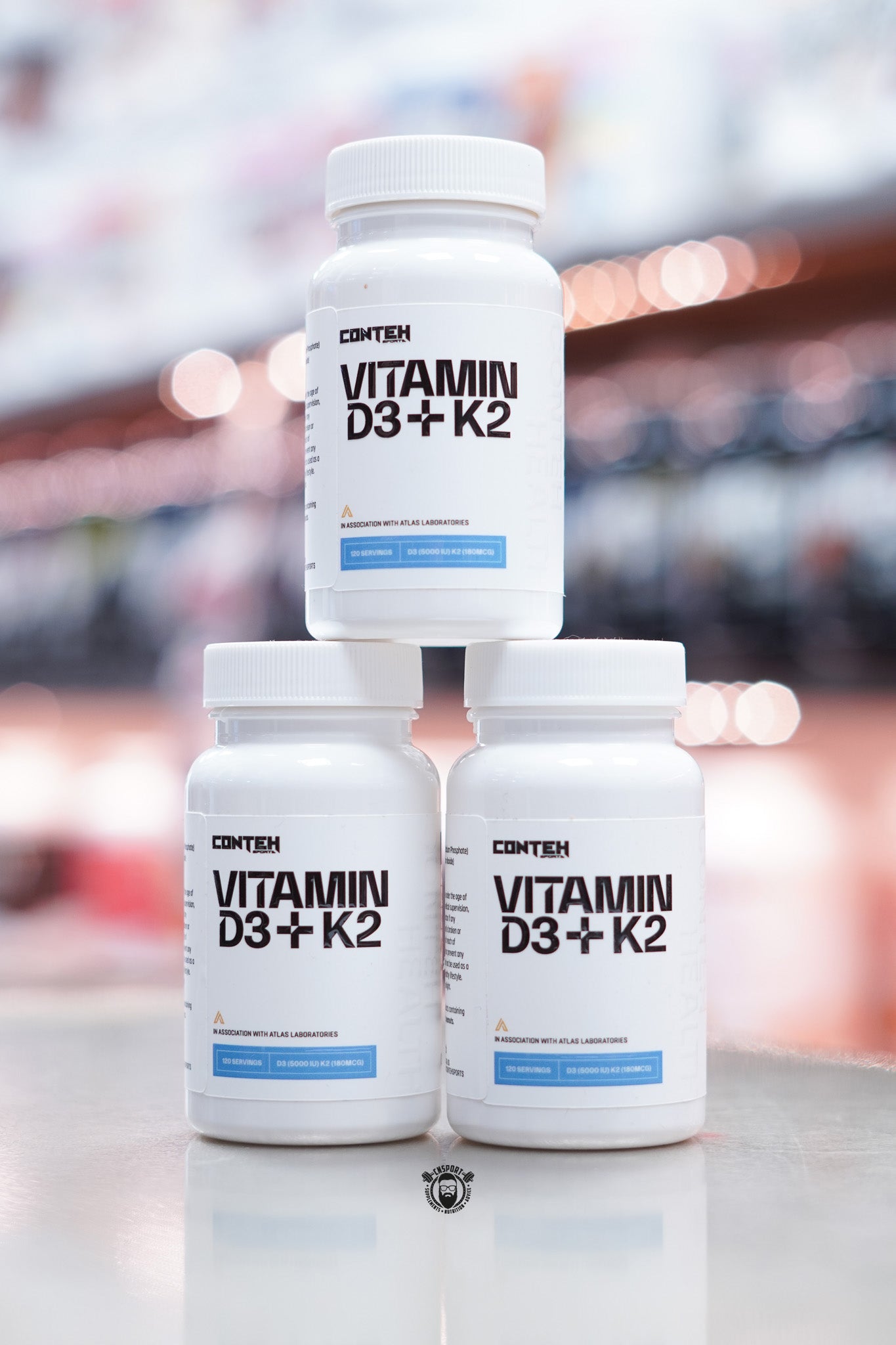 Front view of three Conteh Sports Vitamin D3 + K2 supplement bottles – one bottle stacked on top of two others, with clear product branding and label design.