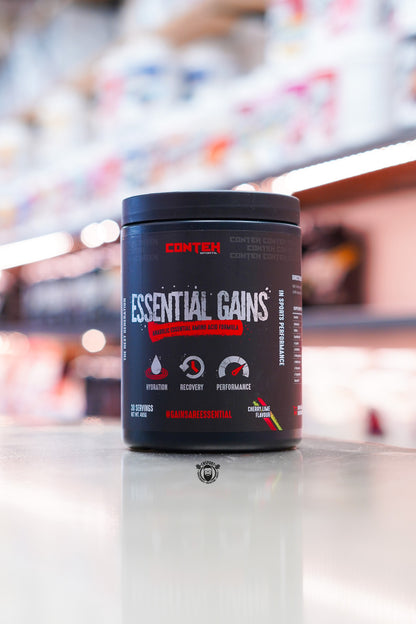 Conteh Sports Essential Gains amino acid formula tub, Cherry Lime flavour, displayed on supplement store counter.