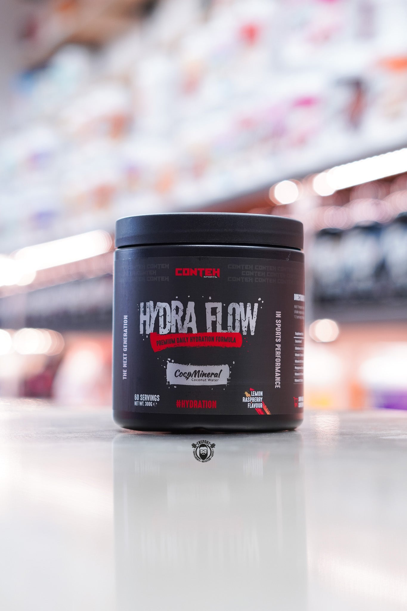Conteh Sports Hydra Flow hydration powder in Lemon Raspberry flavour – 60 servings, with red and yellow accents and CocoMineral coconut water label.