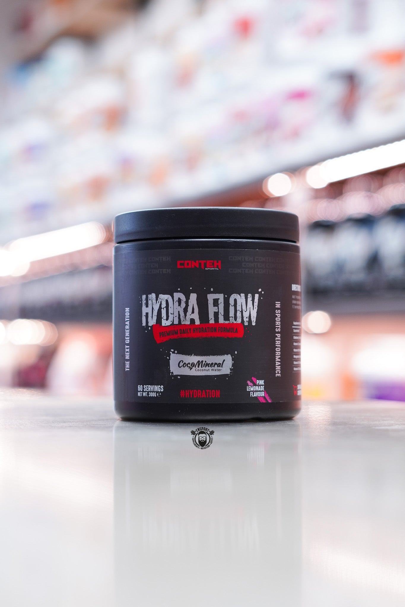 Conteh Sports Hydra Flow hydration supplement in Pink Lemonade flavour – 60 servings, pink accent details and CocoMineral feature on black tub.