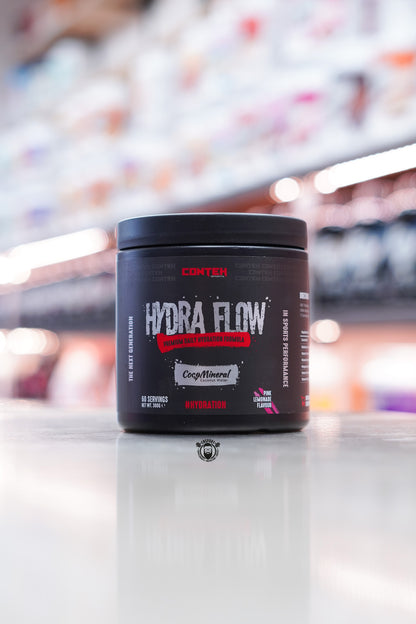 Conteh Sports Hydra Flow hydration supplement in Pink Lemonade flavour – 60 servings, pink accent details and CocoMineral feature on black tub.