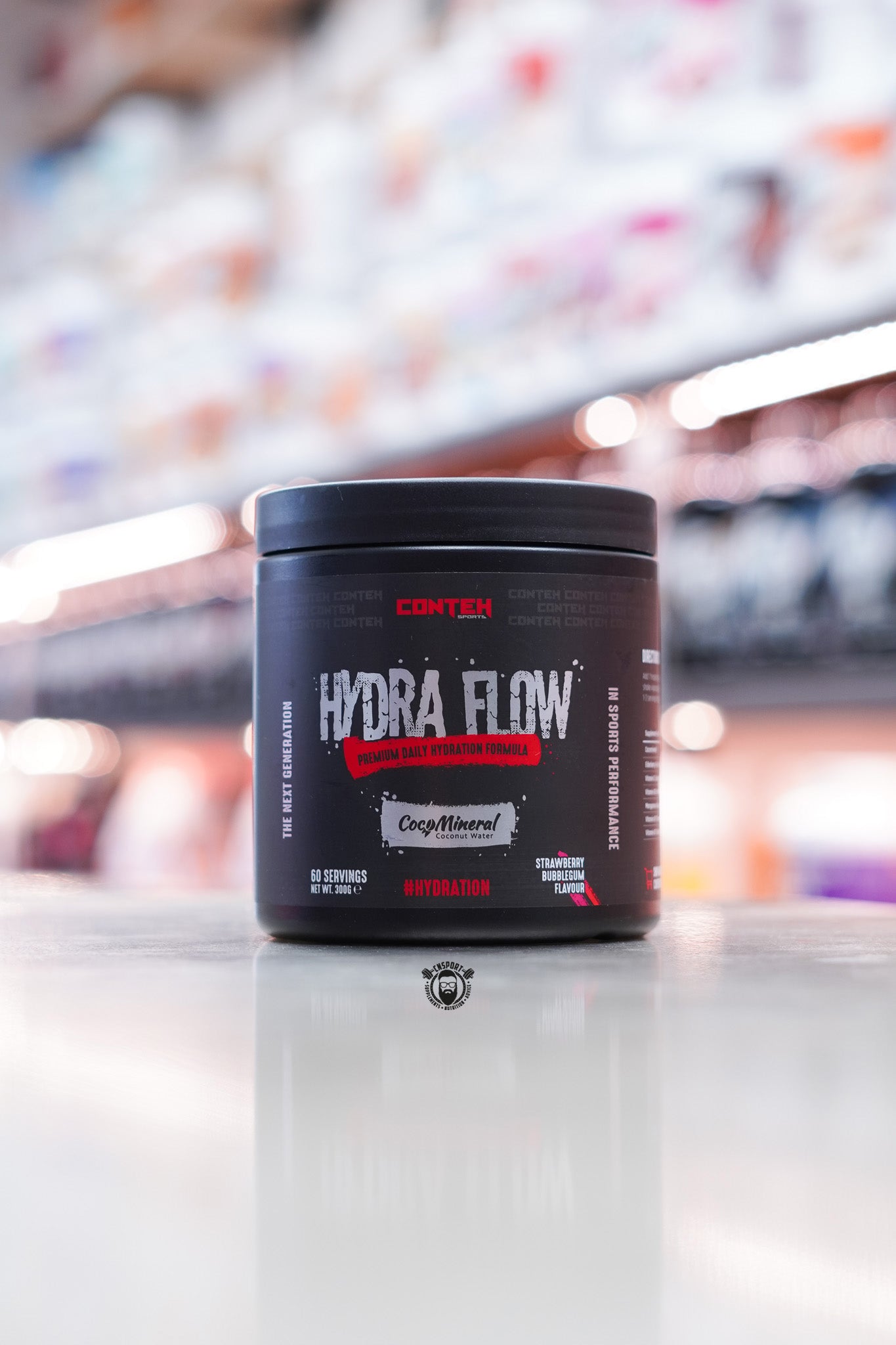 Conteh Sports Hydra Flow hydration product in Strawberry Bubblegum flavour – 60 serving container, red and bubblegum pink themed accents with CocoMineral logo.