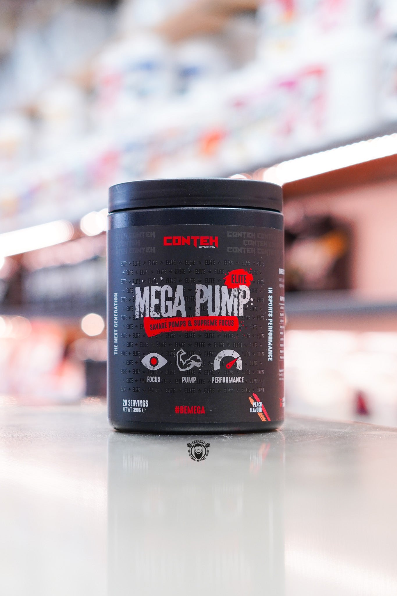Conteh Sports Mega Pump Elite pre-workout tub, Peach flavour, displayed on supplement store counter.