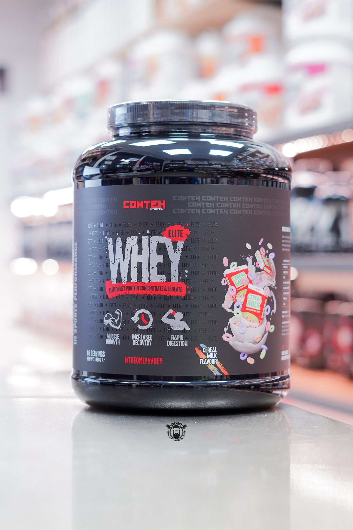 Conteh Sports Whey Elite protein powder, Cereal Milk flavour, 66 servings (1.98kg) black tub displayed on supplement store counter.