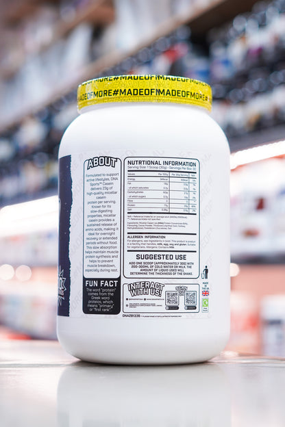 DNA Sports Casein Micellar Casein Protein Chocolate Milkshake nutritional panel and supplement facts label on retail counter with blurred supplement store background
