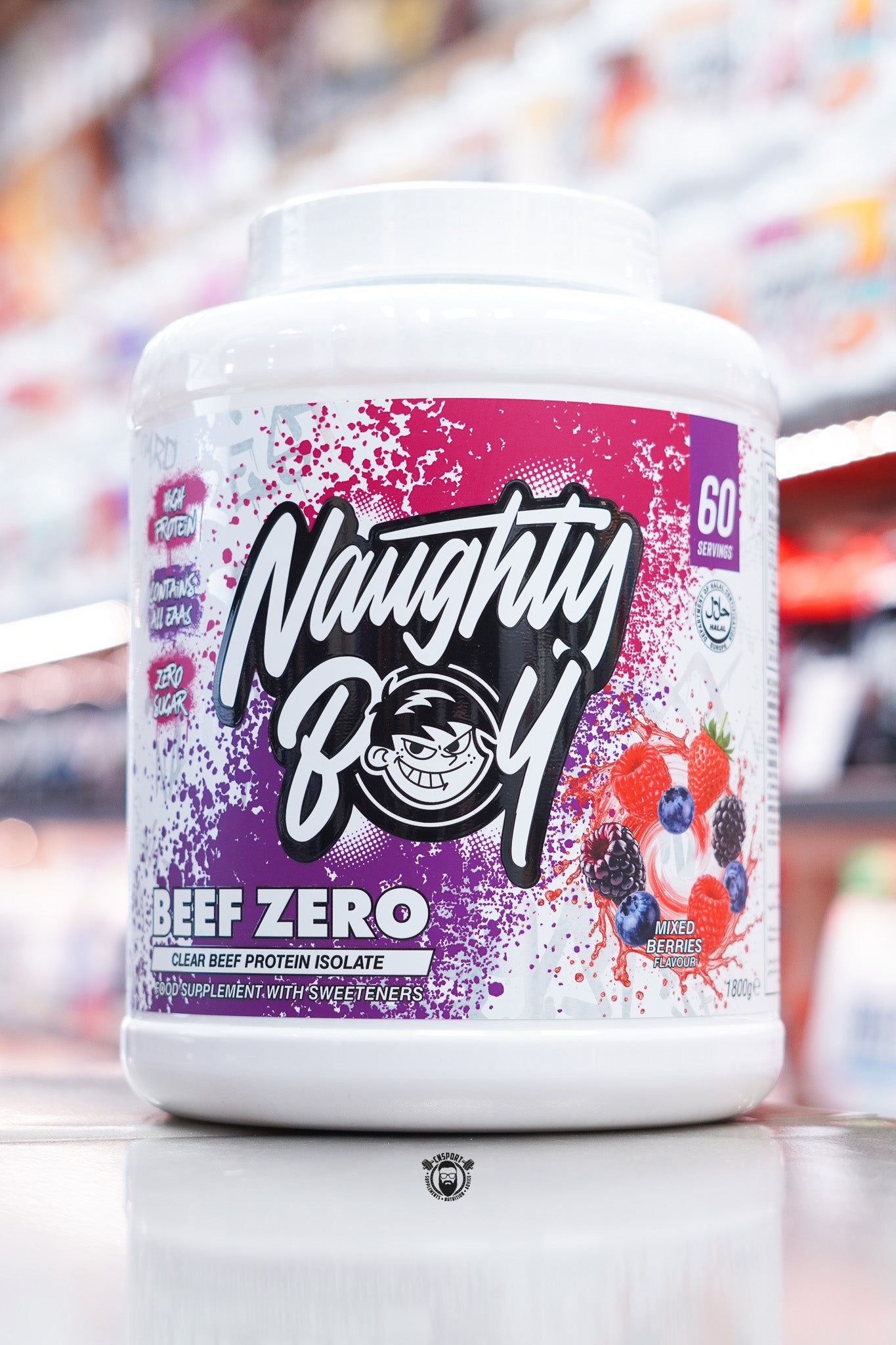 Front of Naughty Boy Beef Zero Mixed Berries 1.8kg tub with purple and pink splatter design, Naughty Boy logo, and mixed berry imagery including raspberries, blackberries, and blueberries.