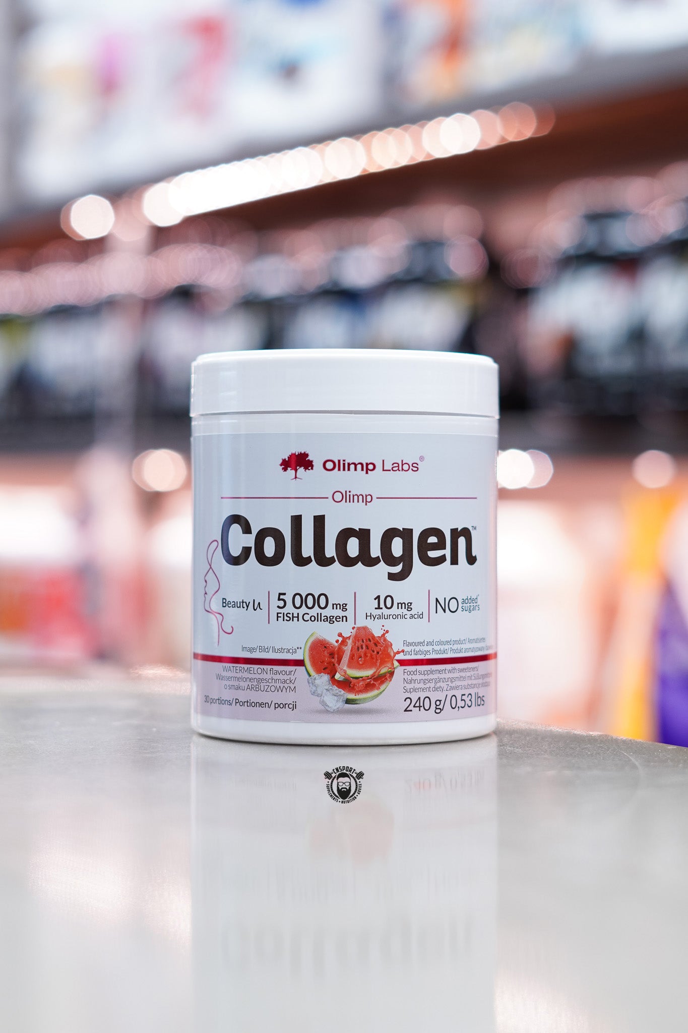 Front view of Olimp Collagen powder in watermelon flavour, featuring 5000 mg fish collagen, 10 mg hyaluronic acid, and “No added sugars” claim.