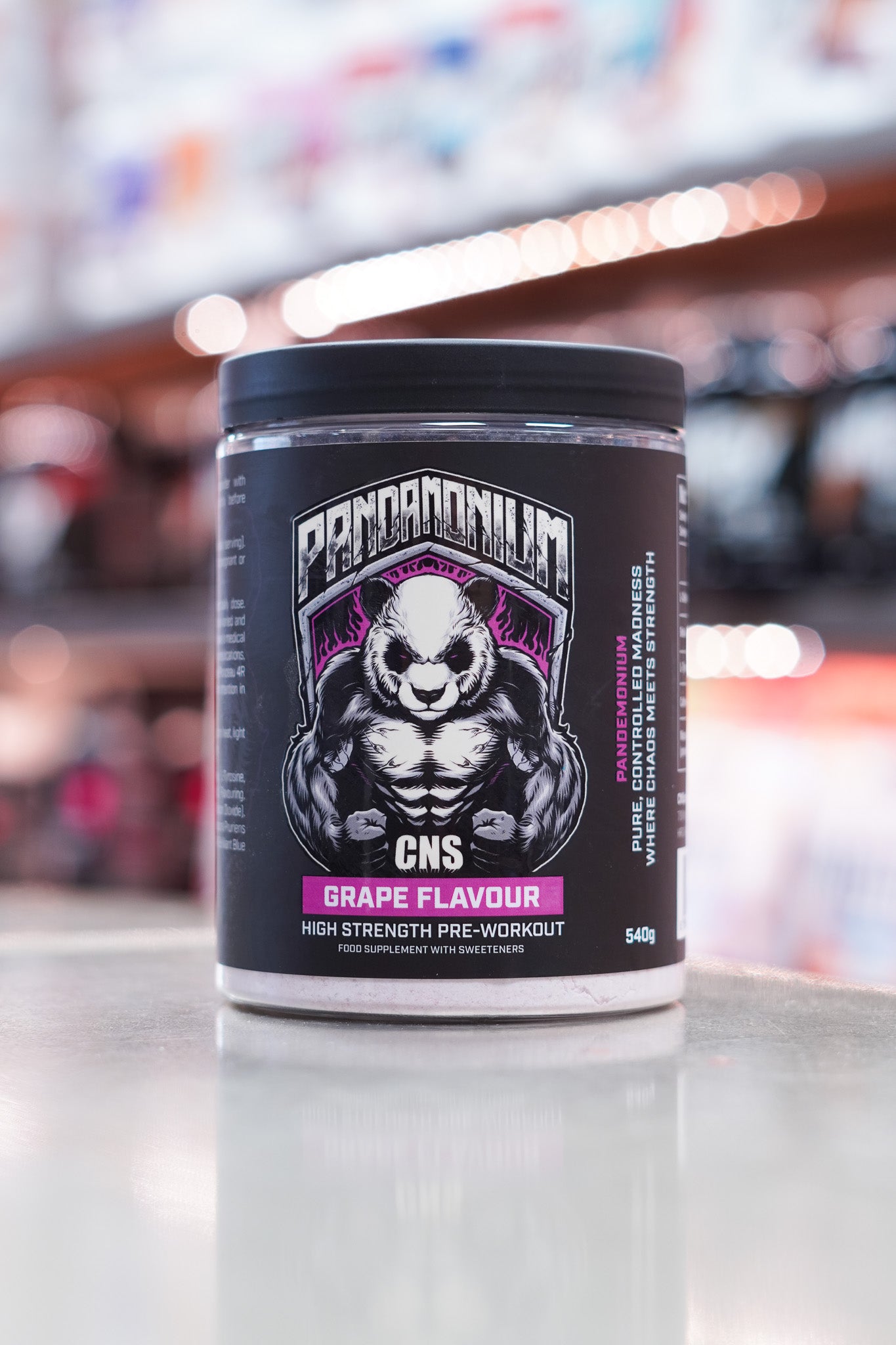 Front-facing image of CNSport Pandamonium Pre-Workout Grape flavour featuring panda logo with purple highlights and high-strength pre-workout branding.